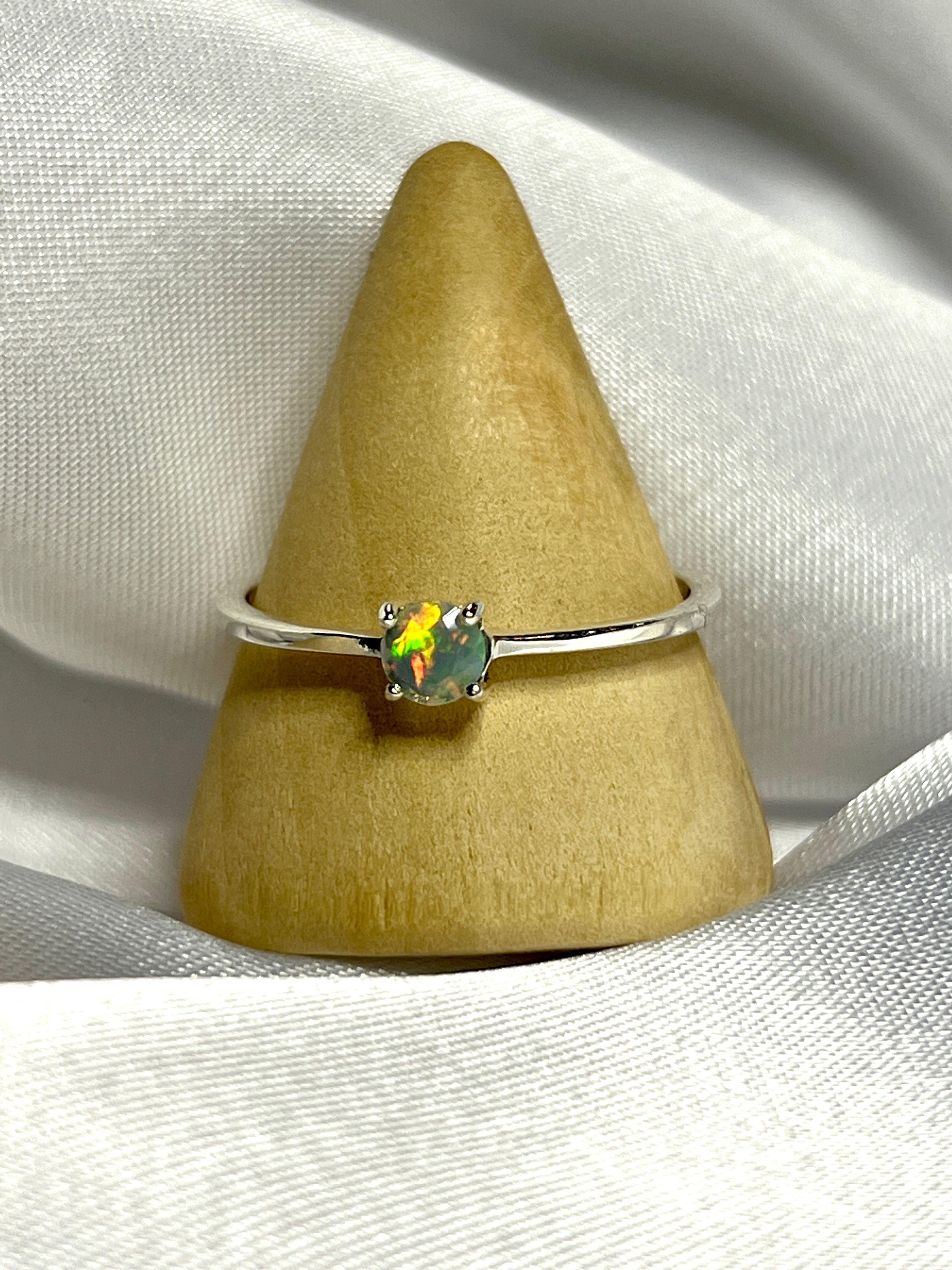 An elegant silver ring with a Dainty Prong Set Facet Cut Ethiopian Opal stone.