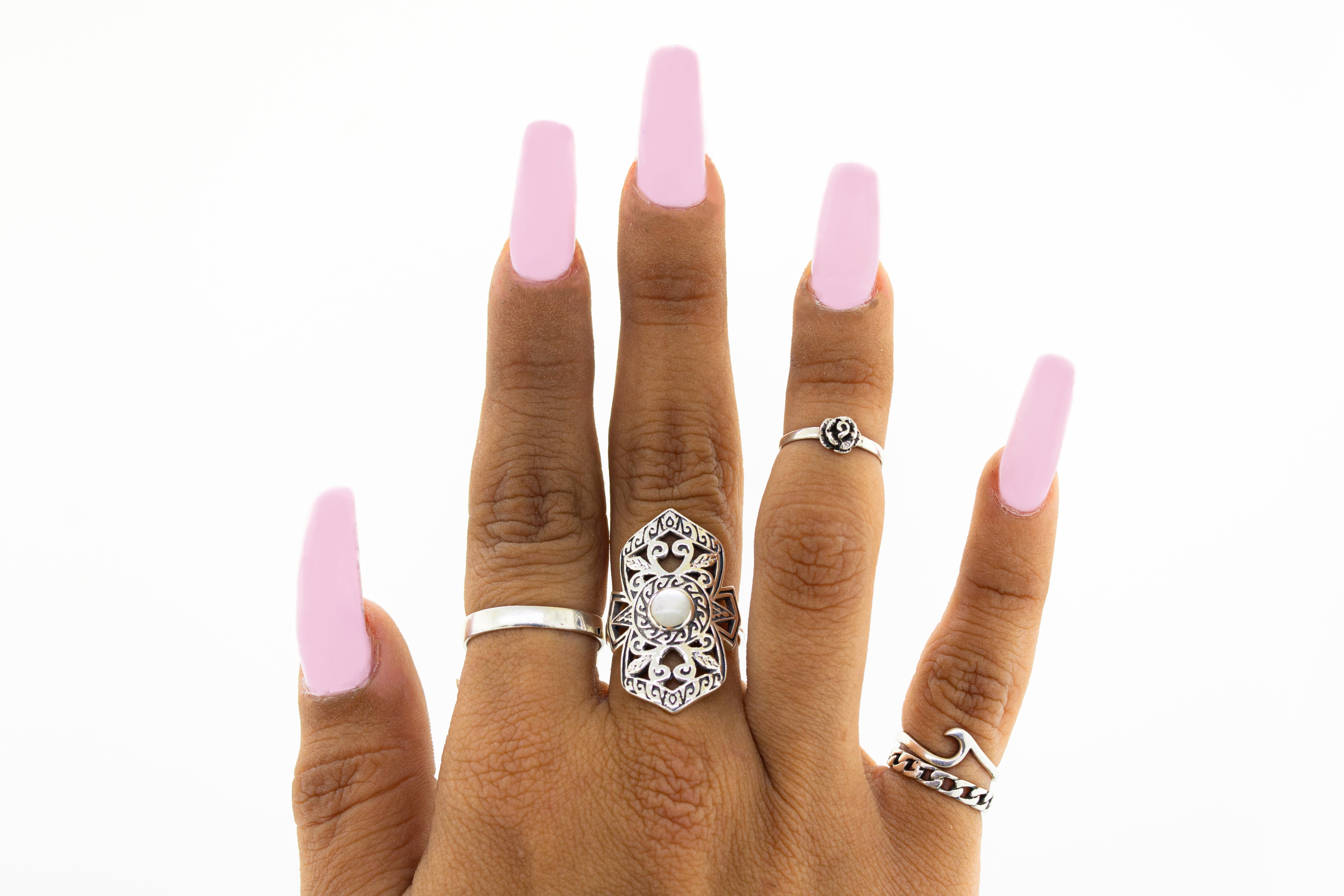 A woman's hand with an Elaborate Filigree Shield Ring with Stone.