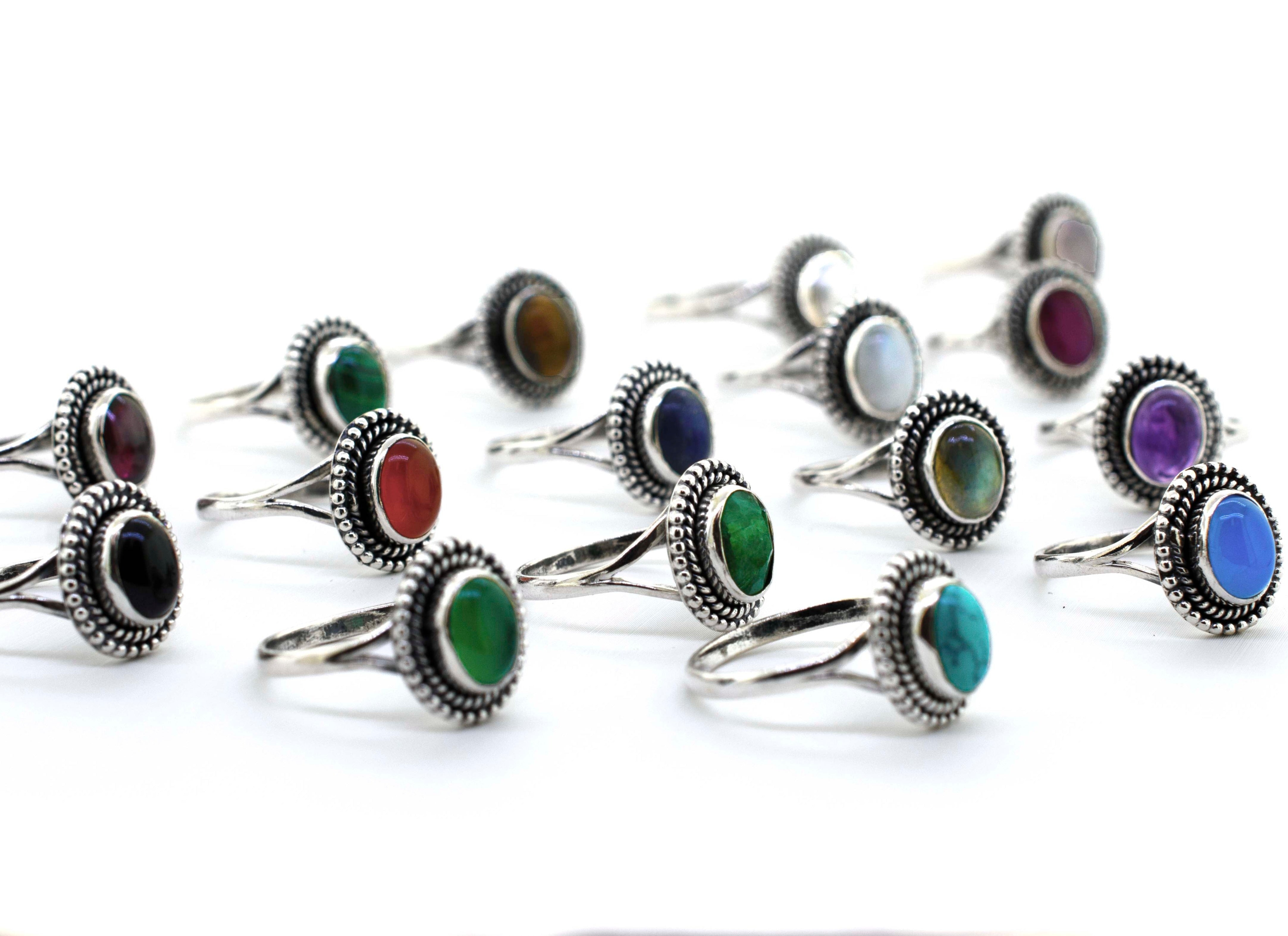 A group of Gemstone Oval Shield Rings adorned with stone cabochons in various colors.
