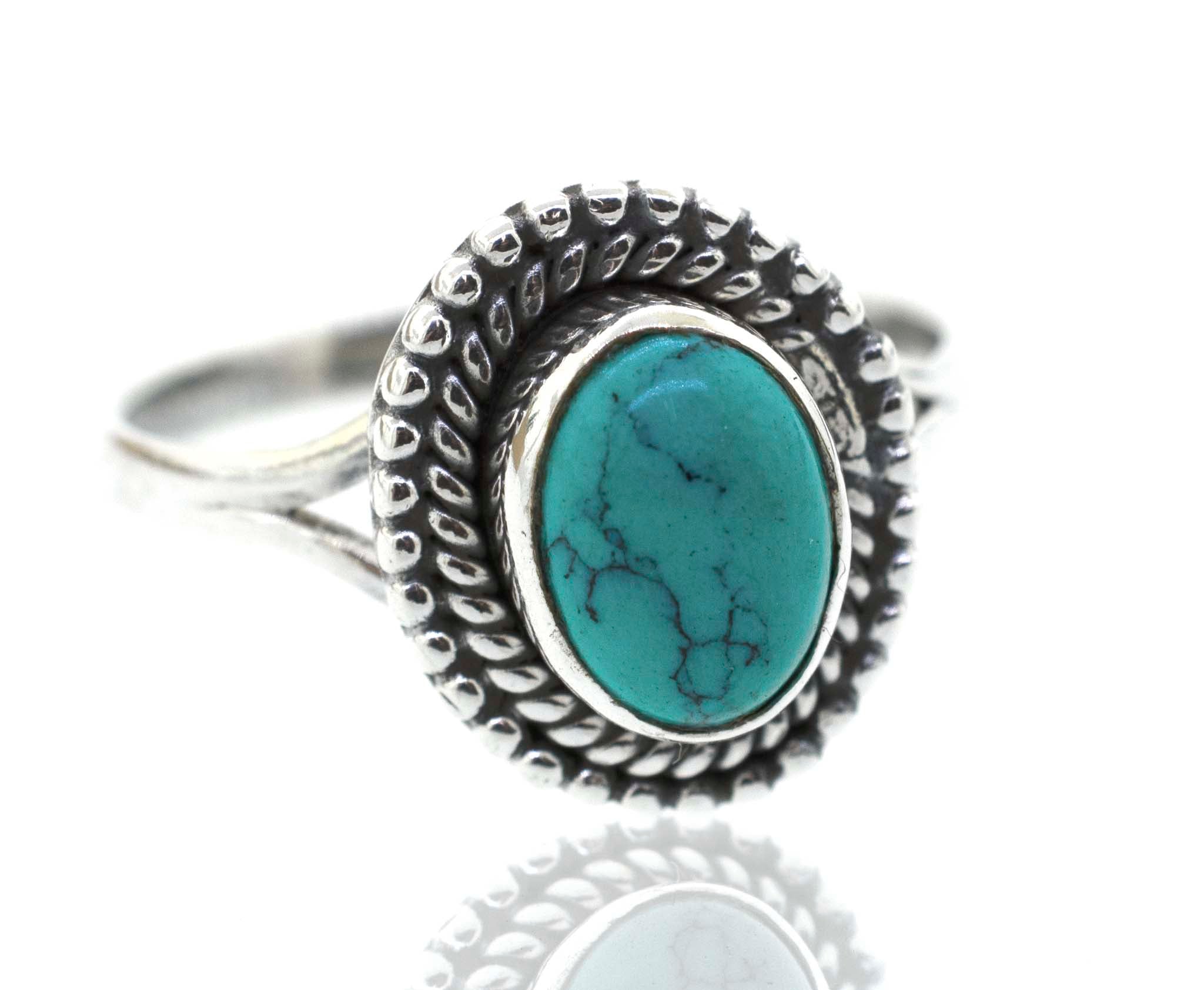 A Gemstone Oval Shield Ring with a turquoise stone.
