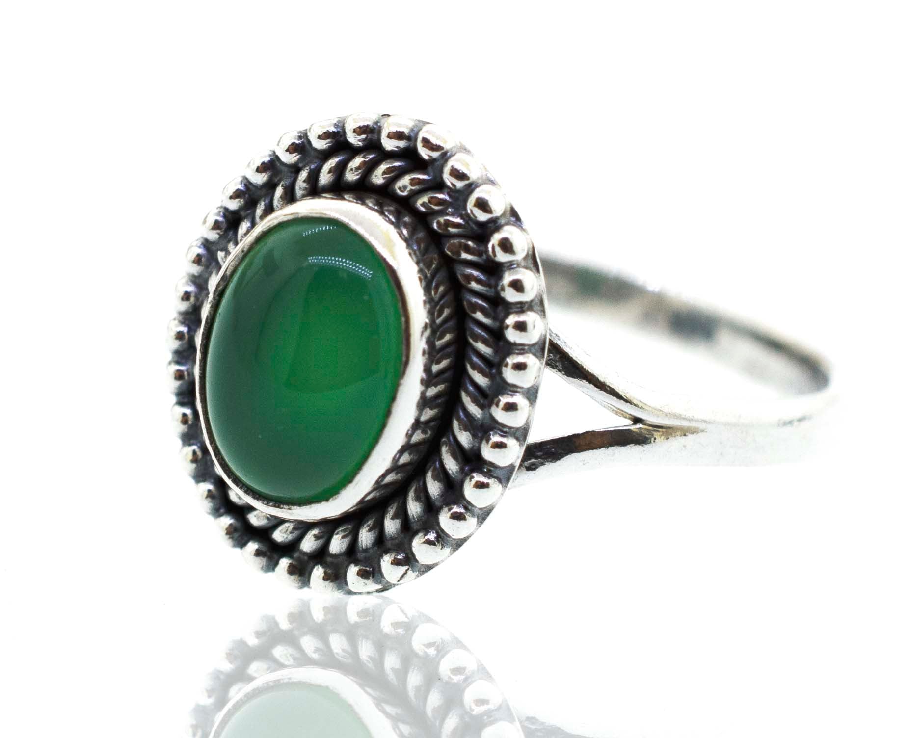 A Gemstone Oval Shield Ring with a green jade stone.
