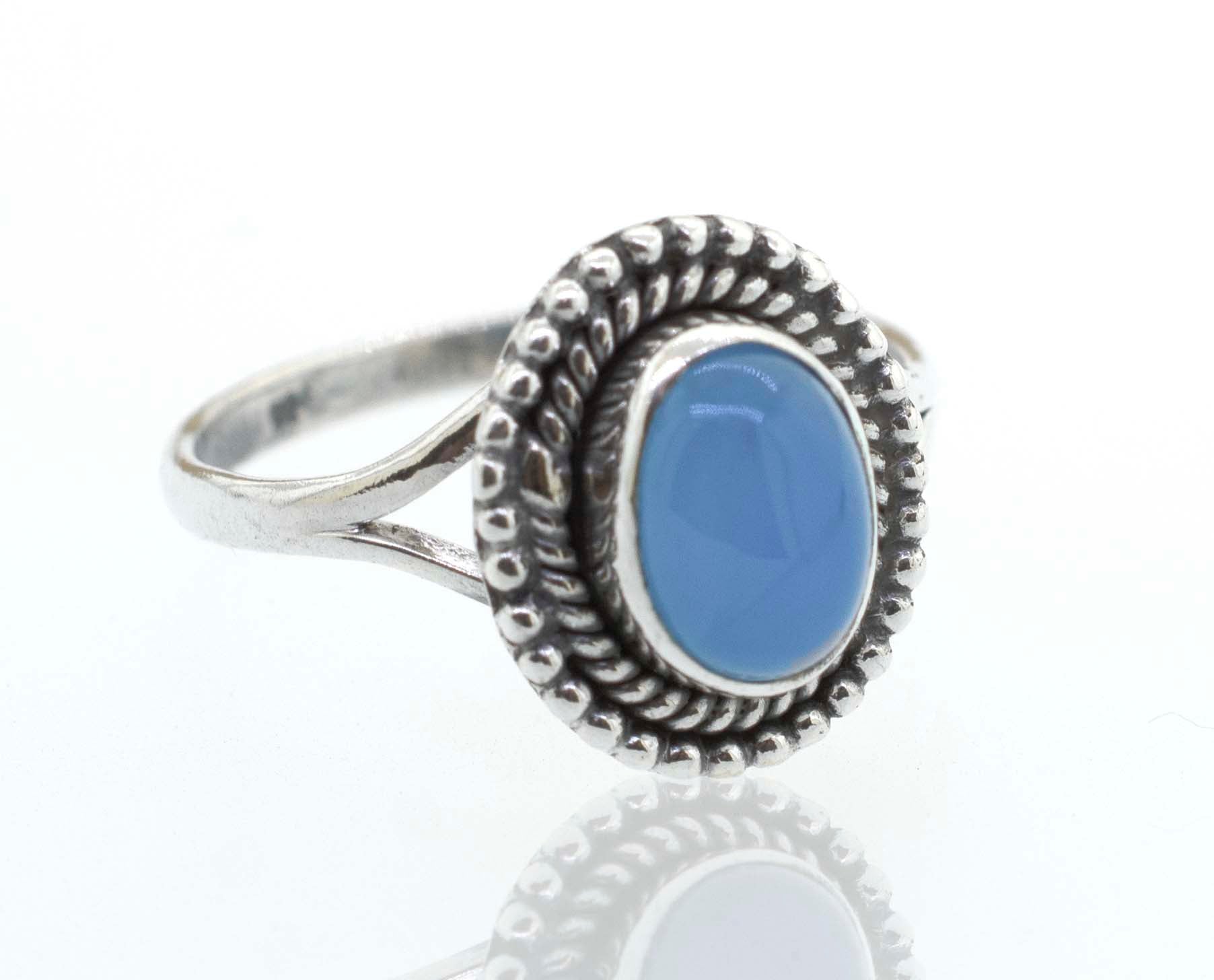 A boho Gemstone Oval Shield Ring with a blue stone.