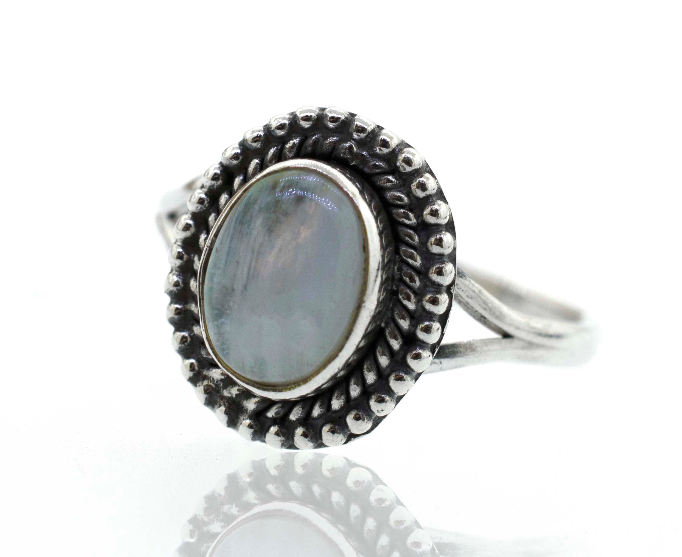 A boho silver ring with an oval stone, featuring mother of pearl from Santa Cruz has been replaced with "Gemstone Oval Shield Ring".