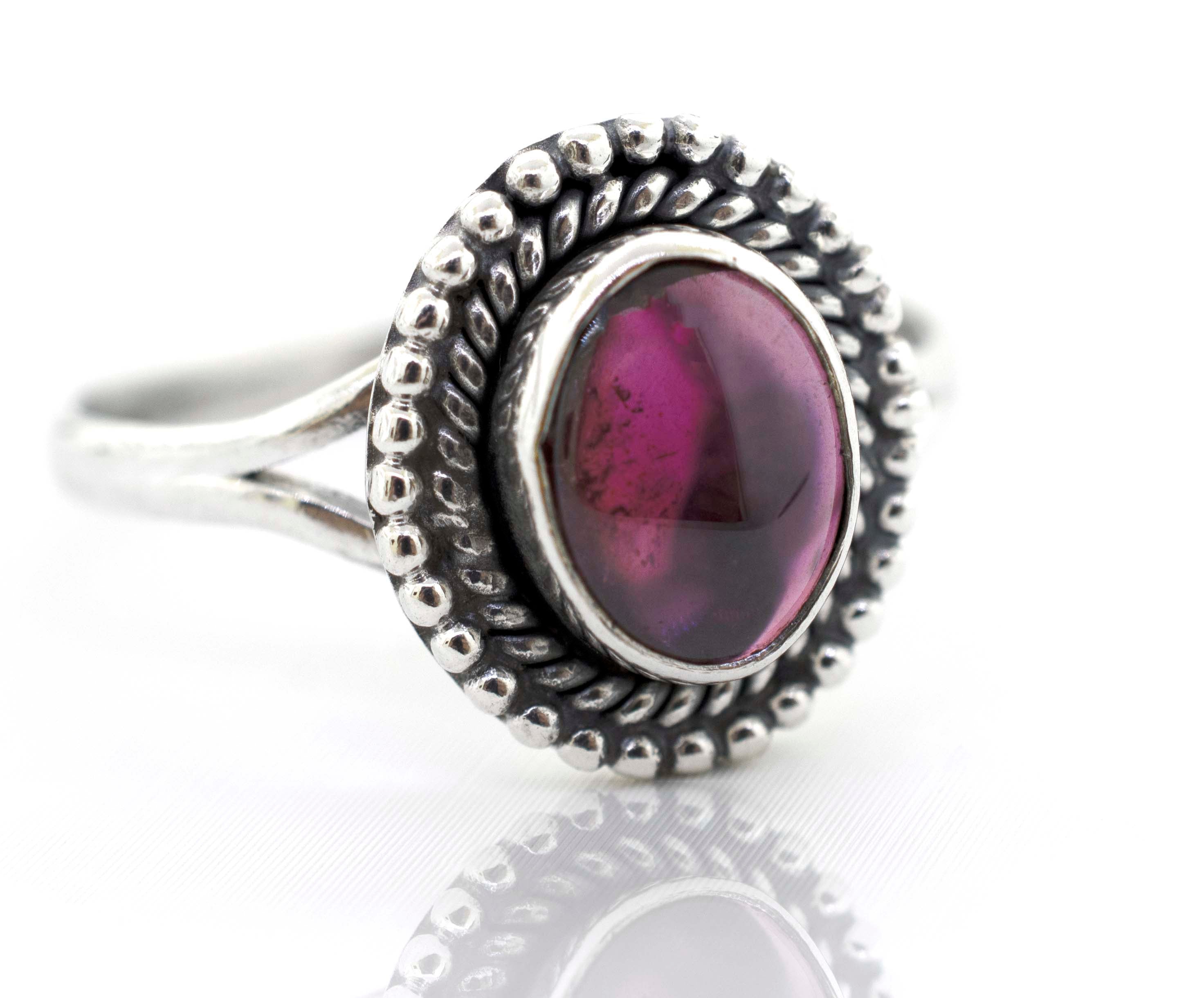 A Super Silver Gemstone Oval Shield Ring with a pink tourmaline gemstone.