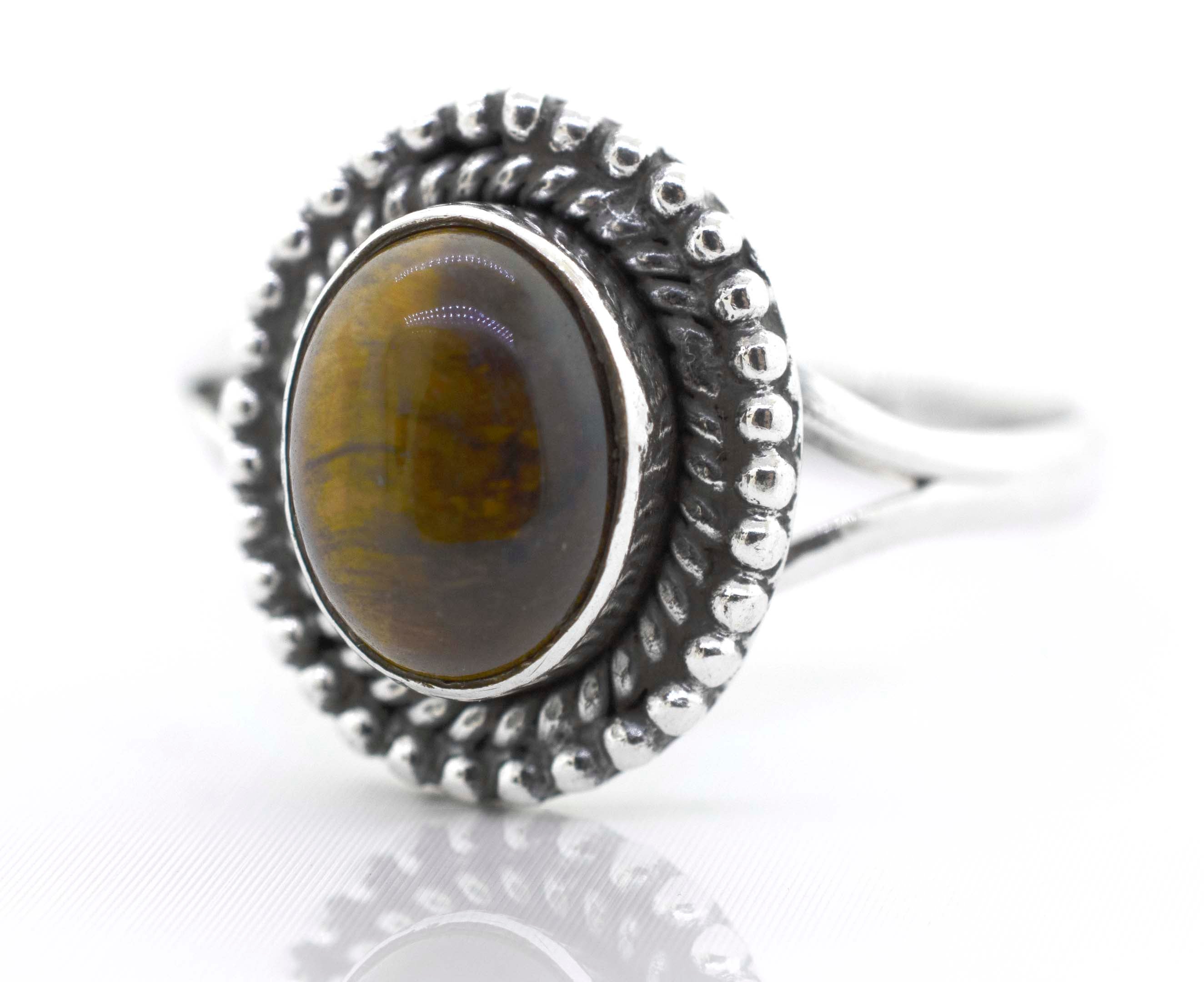 A Super Silver Gemstone Oval Shield Ring with an oval tiger eye stone.