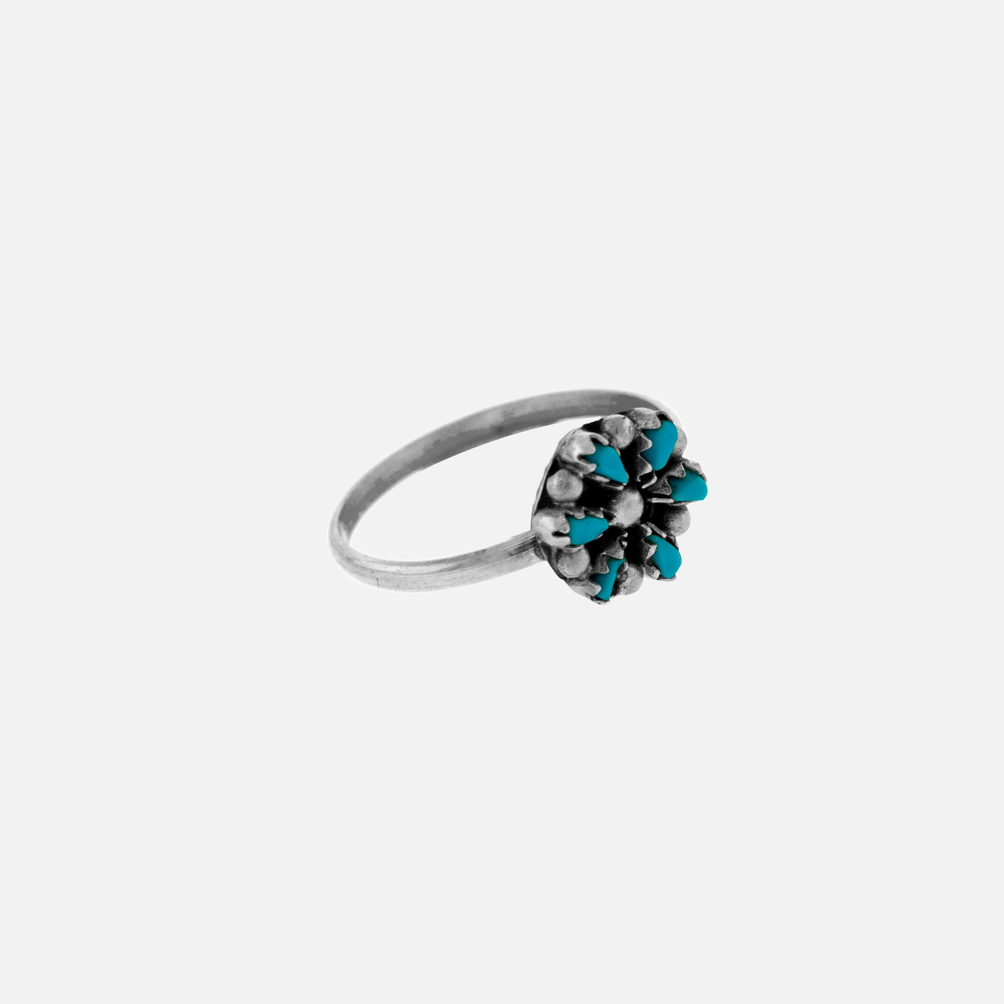 A Small Native American Turquoise Flower Ring with turquoise stones.