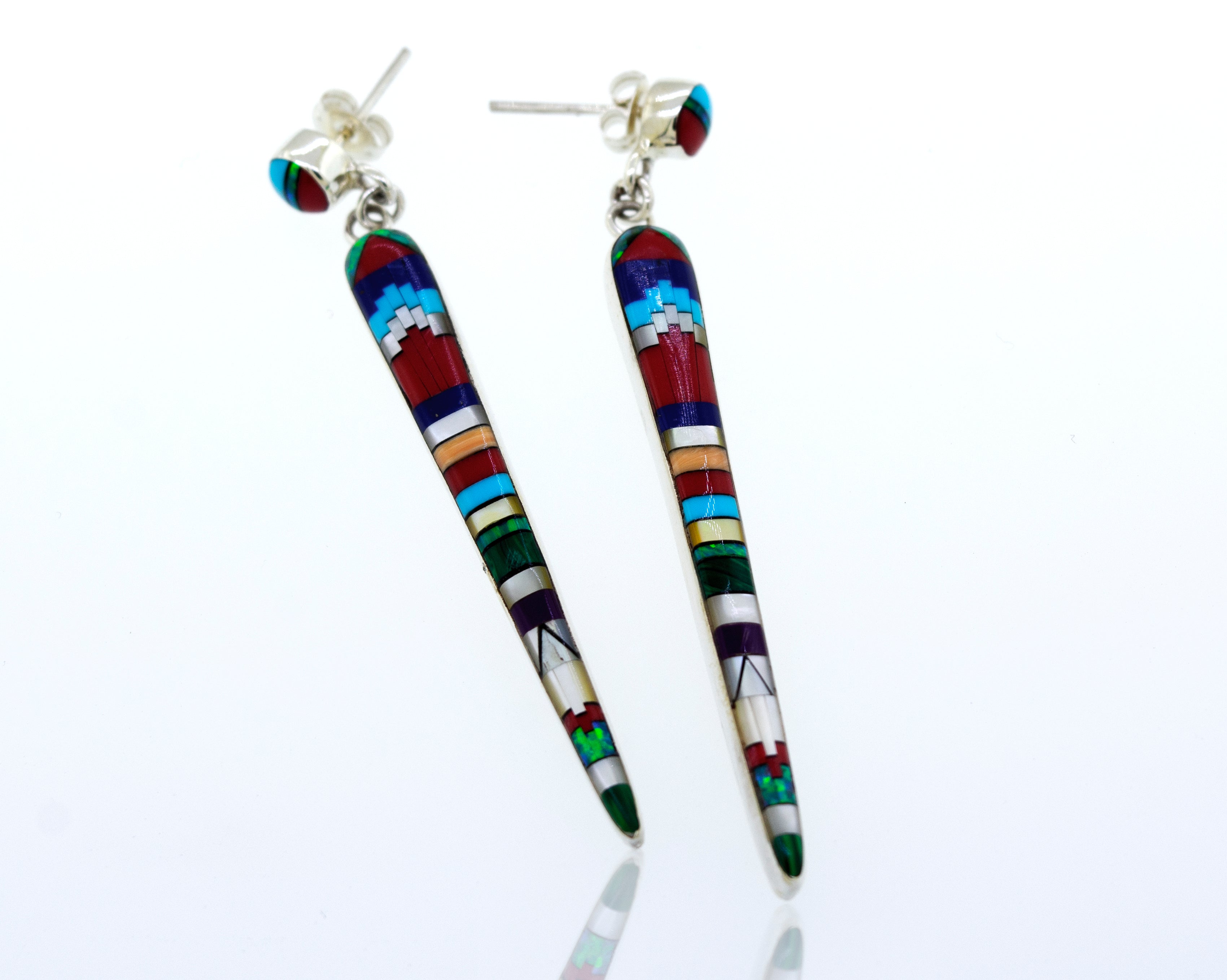 A pair of Super Silver Beautiful Designer Multi-Stone Elongated Teardrop Earrings with colorful inlaid details, crafted from sterling silver, resting on a white surface.