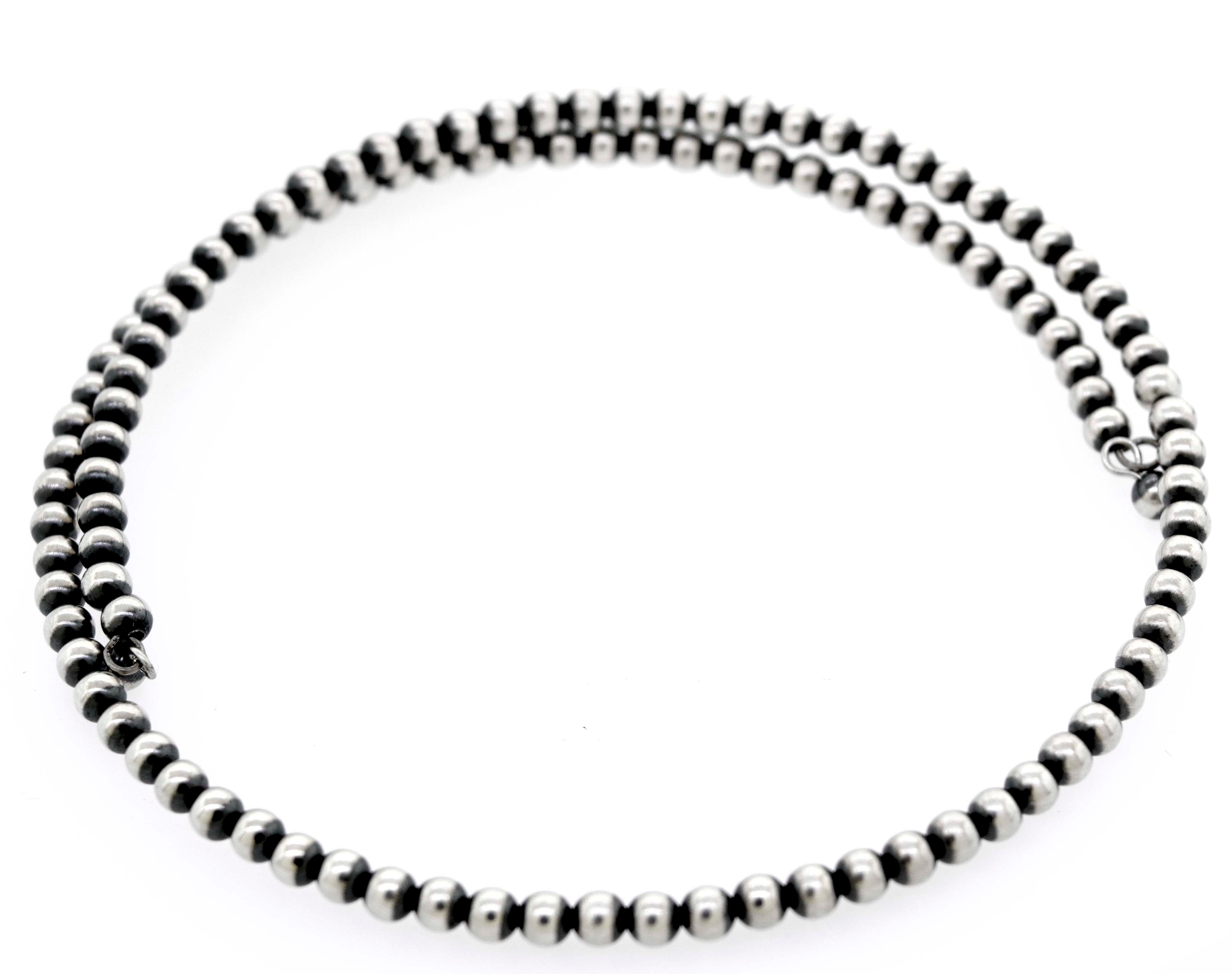 A Handcrafted Navajo Pearl Choker from Super Silver on a white background.