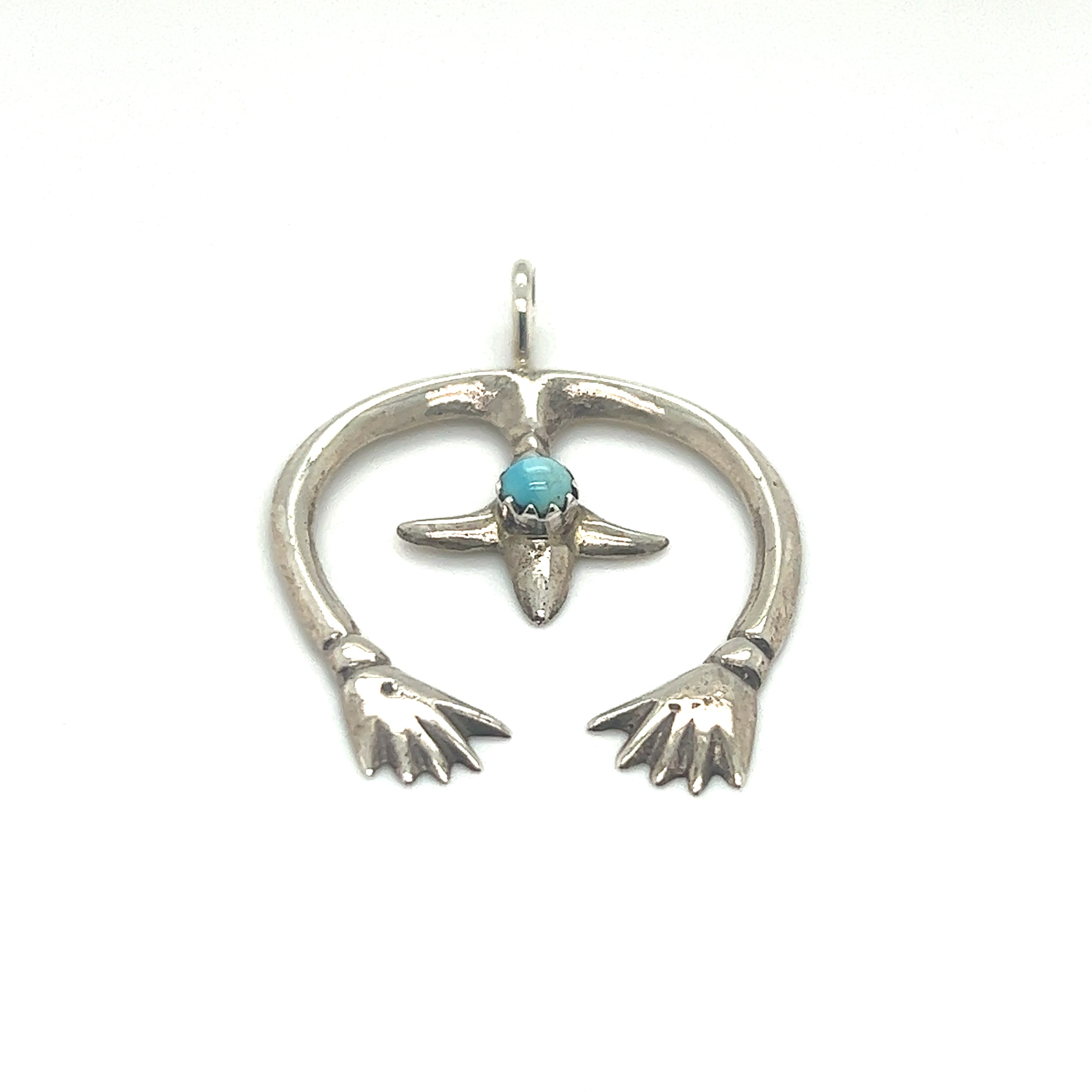 A southwest-inspired Super Silver Native American Naja Pendant With Turquoise.