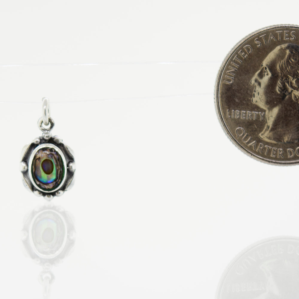 A small Super Silver pendant with a Beautiful Oval Stone Pendant With Silver Border next to it.
