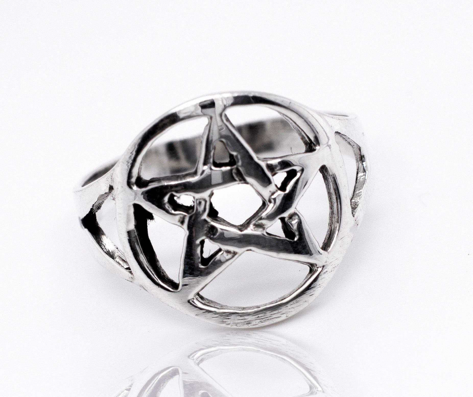 A sterling silver Pentagram Ring on a white surface.