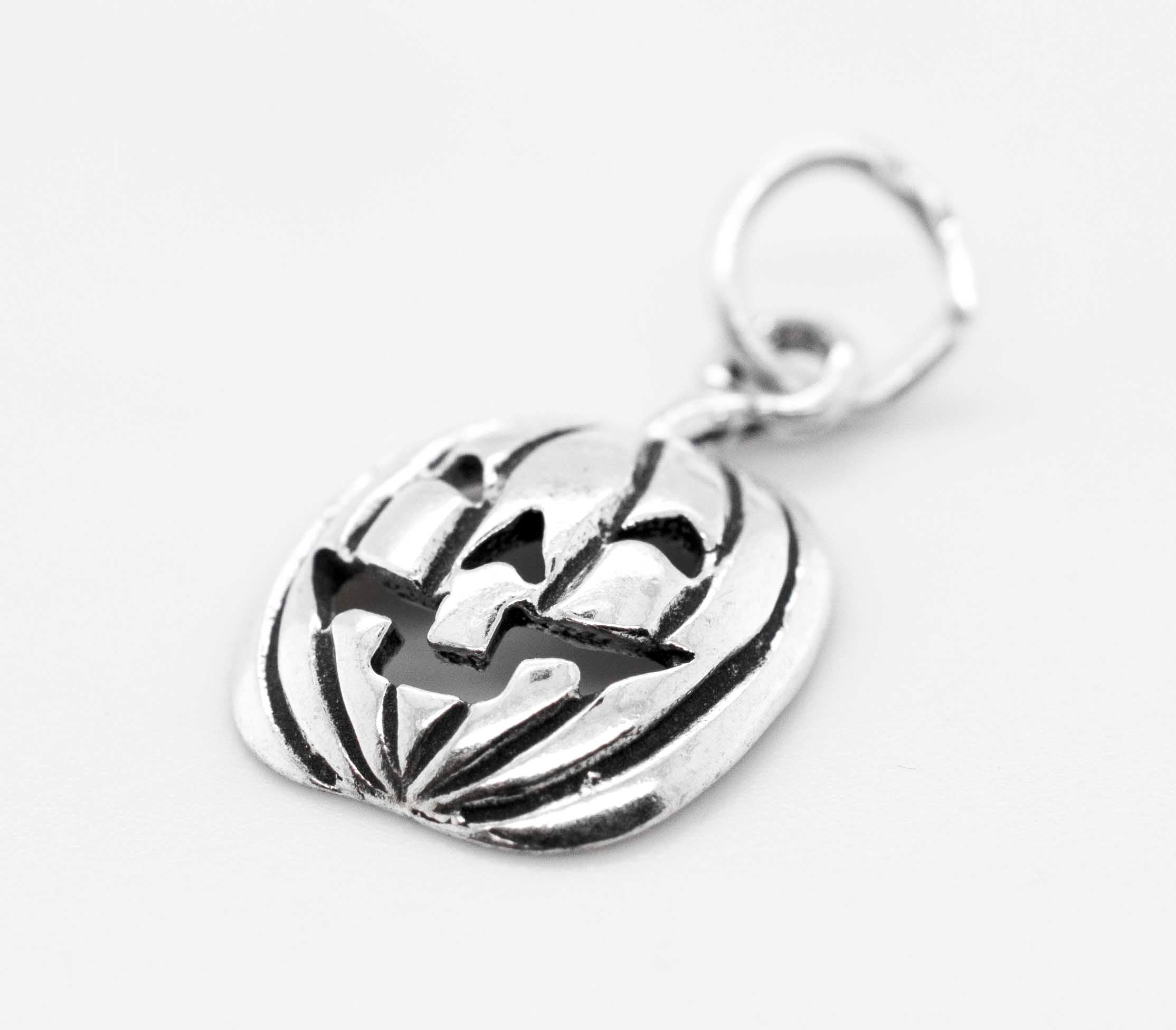 A Halloween-themed Super Silver Jack O' Lantern Charm displayed on a white surface.