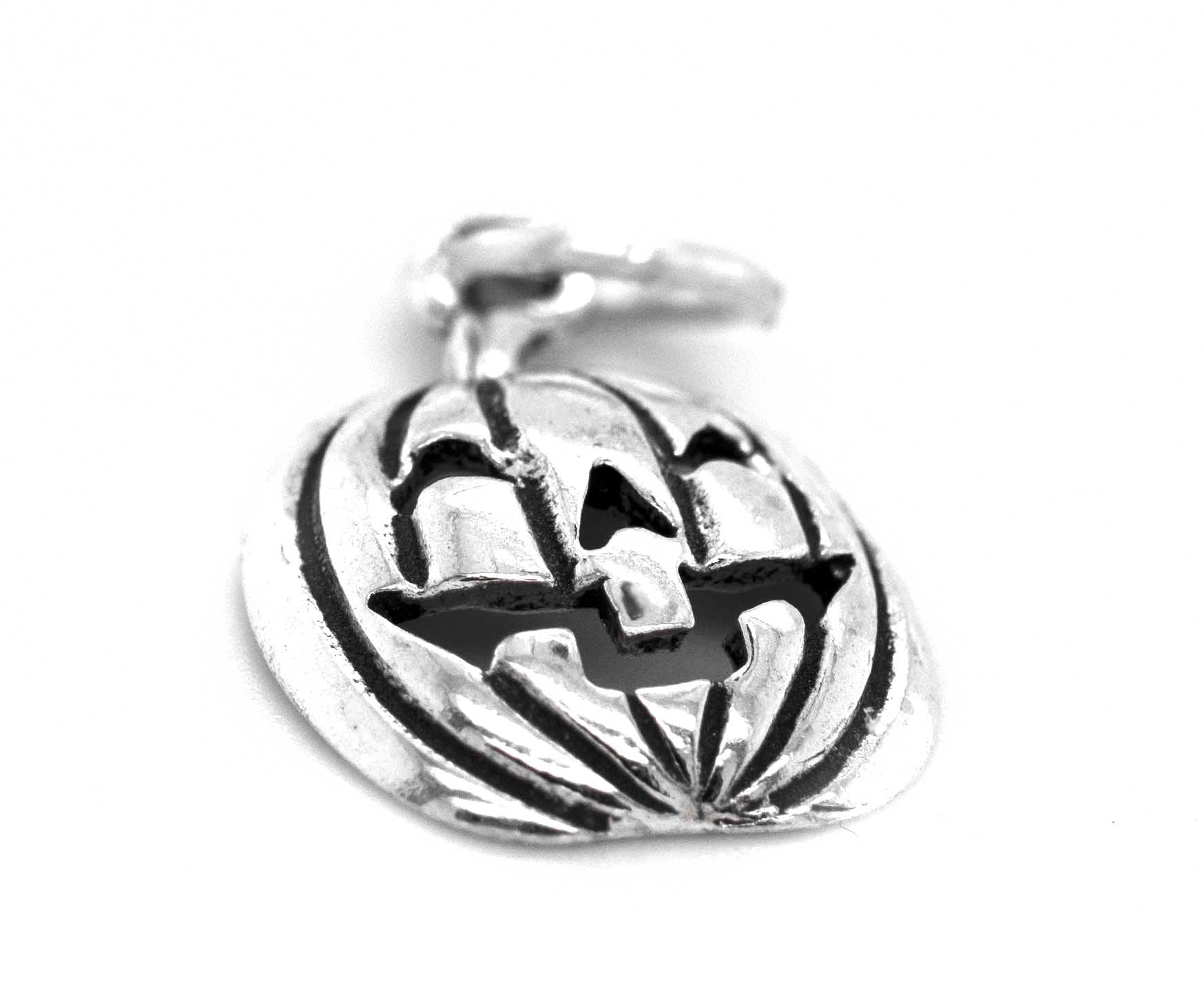 A Halloween-themed Super Silver Jack O' Lantern Charm on a white background.