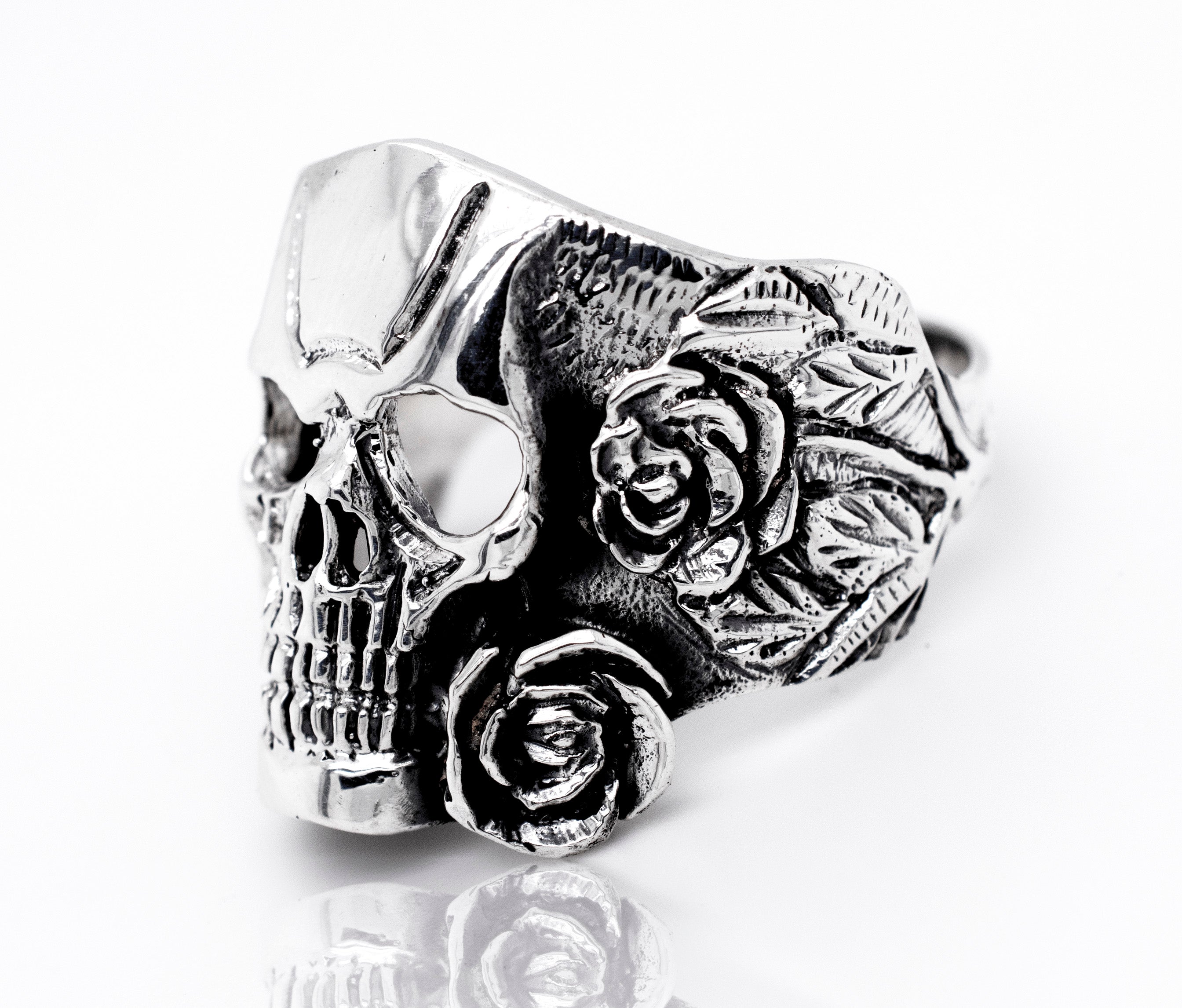 A Skull Ring With Rose Design made of sterling silver adorned with intricate roses.