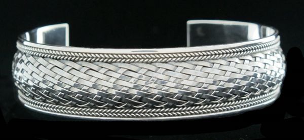 An oxidized Super Silver Woven Silver Cuff Bracelet on a black background.