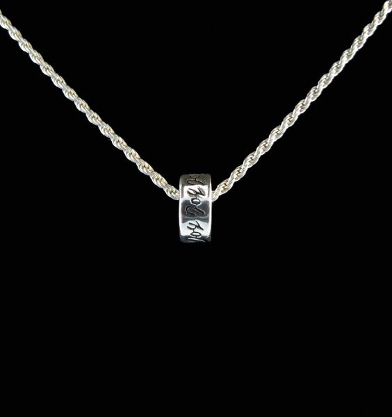 A Super Silver Affirmation Bead Charm made of sterling silver, featuring a small circle pendant.