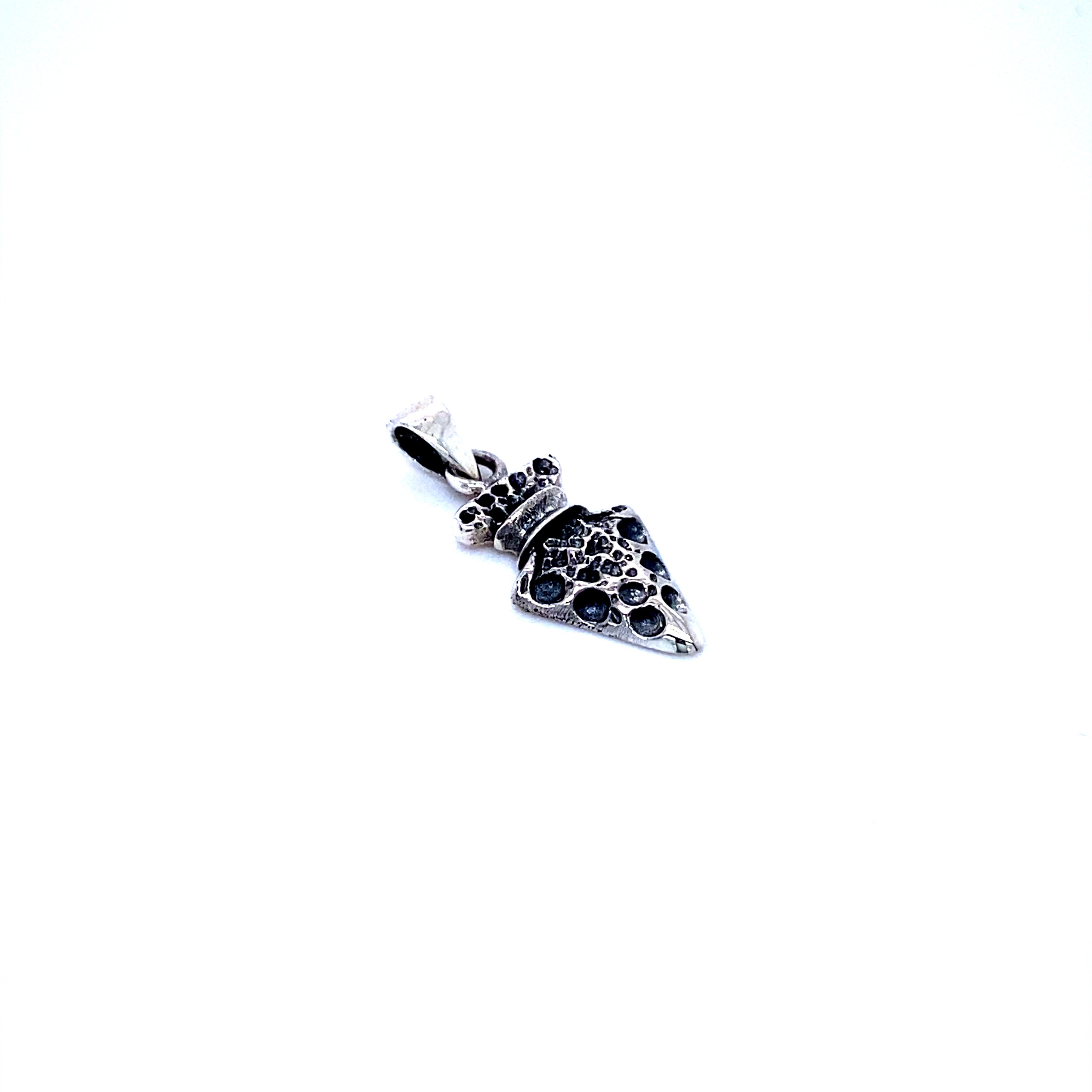 A Tiny Arrowhead Charm pendant from Super Silver, on a white background, serving as a symbol of protection and charm.