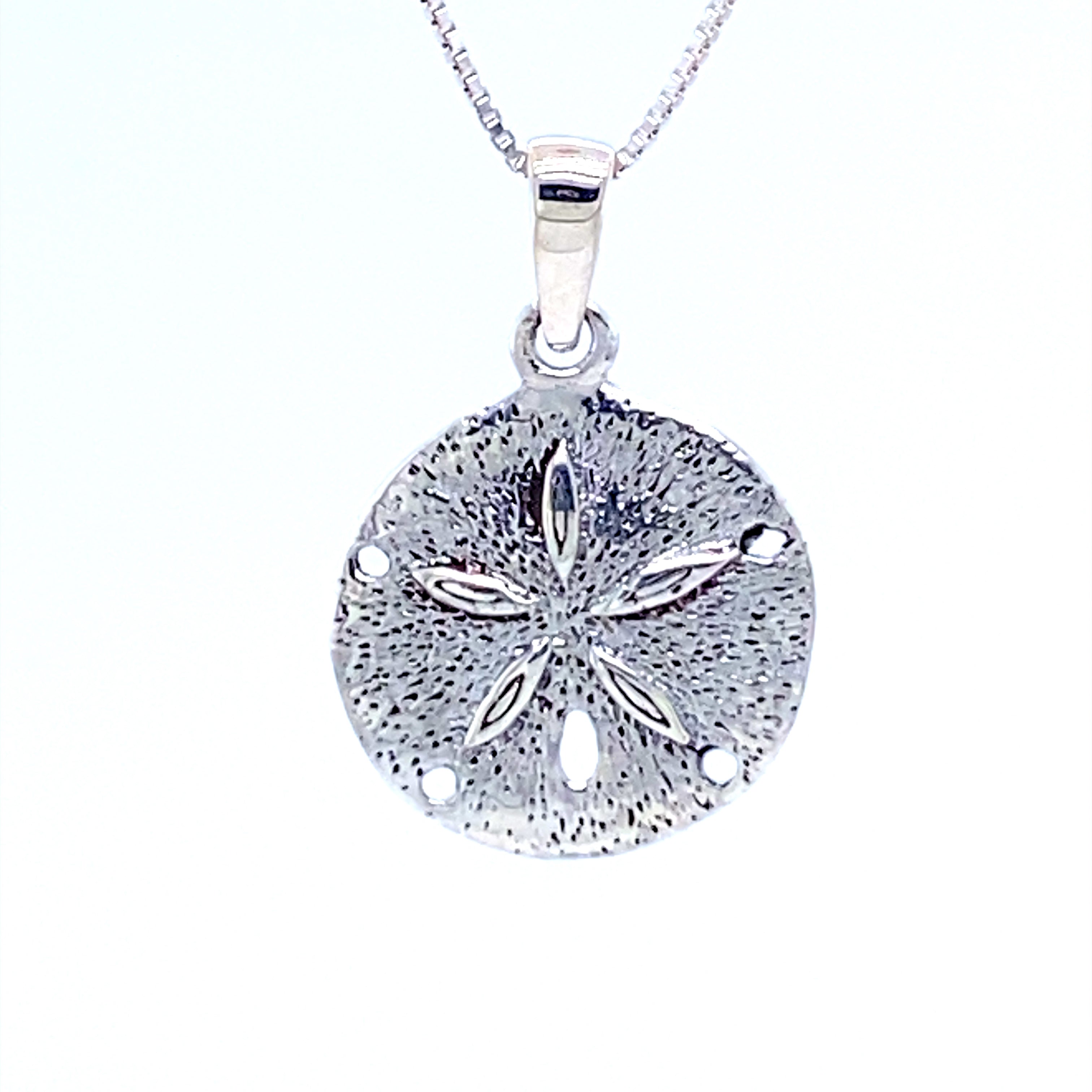 A Small Sand Dollar Pendant on a chain, perfect for a beach lover or someone who appreciates shell necklaces.