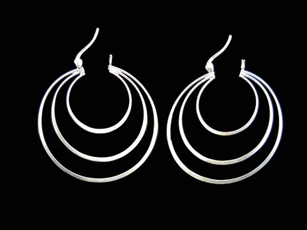 A pair of stunning Super Silver Three Rings Large Hoop Earrings on a black background.