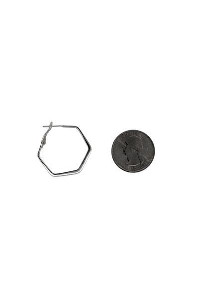 A pair of Small Flat Hexagon Hinged Hoops by Super Silver next to a penny.