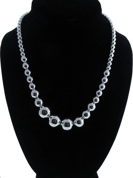 A Super Silver Graduated Silver Bead Necklace, also known as a statement necklace, on a mannequin.