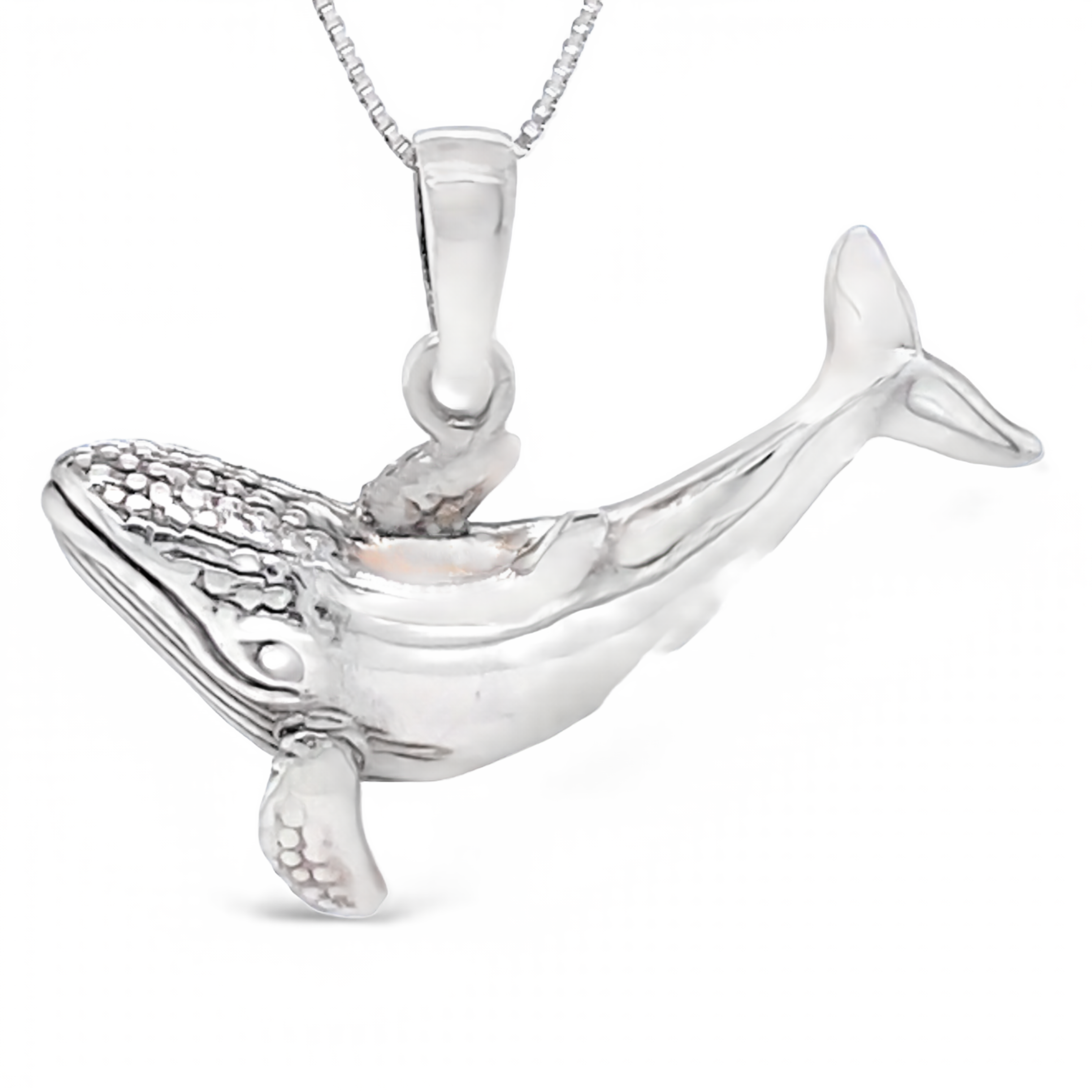 A Super Silver whale pendant on a chain inspired by the Santa Cruz ocean.