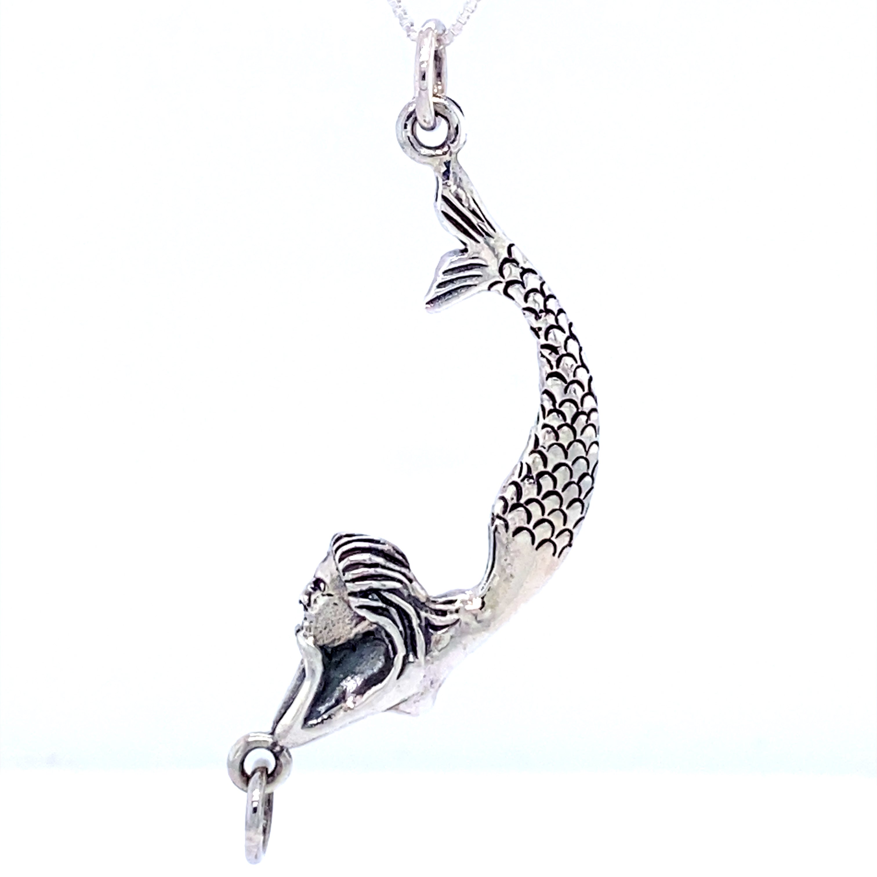 A Lounging Mermaid Pendant, resembling a sea goddess, gracefully hanging from a Super Silver necklace chain.