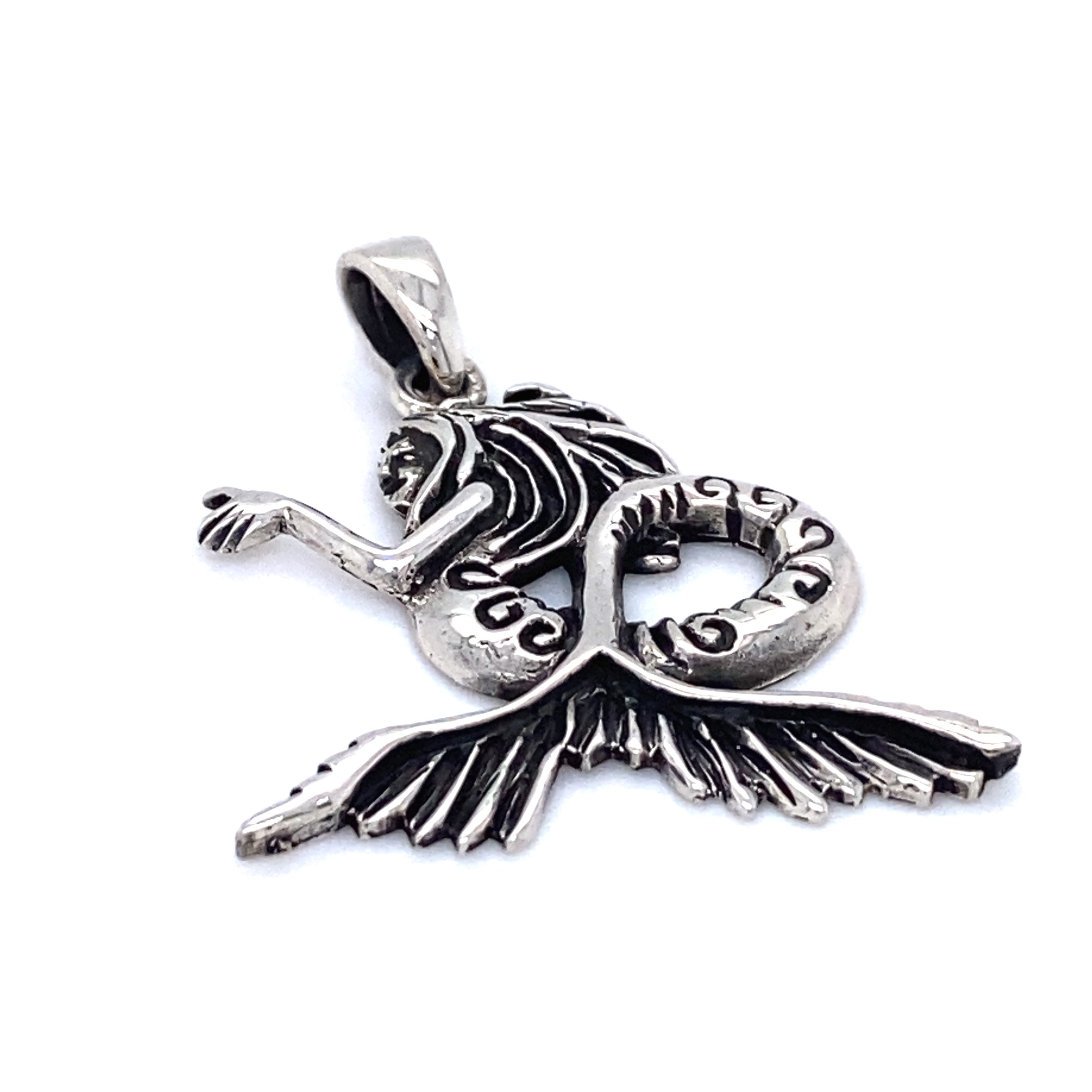 A Super Silver Silver Siren Pendant featuring a seductive mermaid against the backdrop of the blue sea.