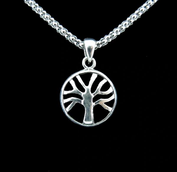A Super Silver Small Round Tree of Life Pendant beautifully displayed on a black background.