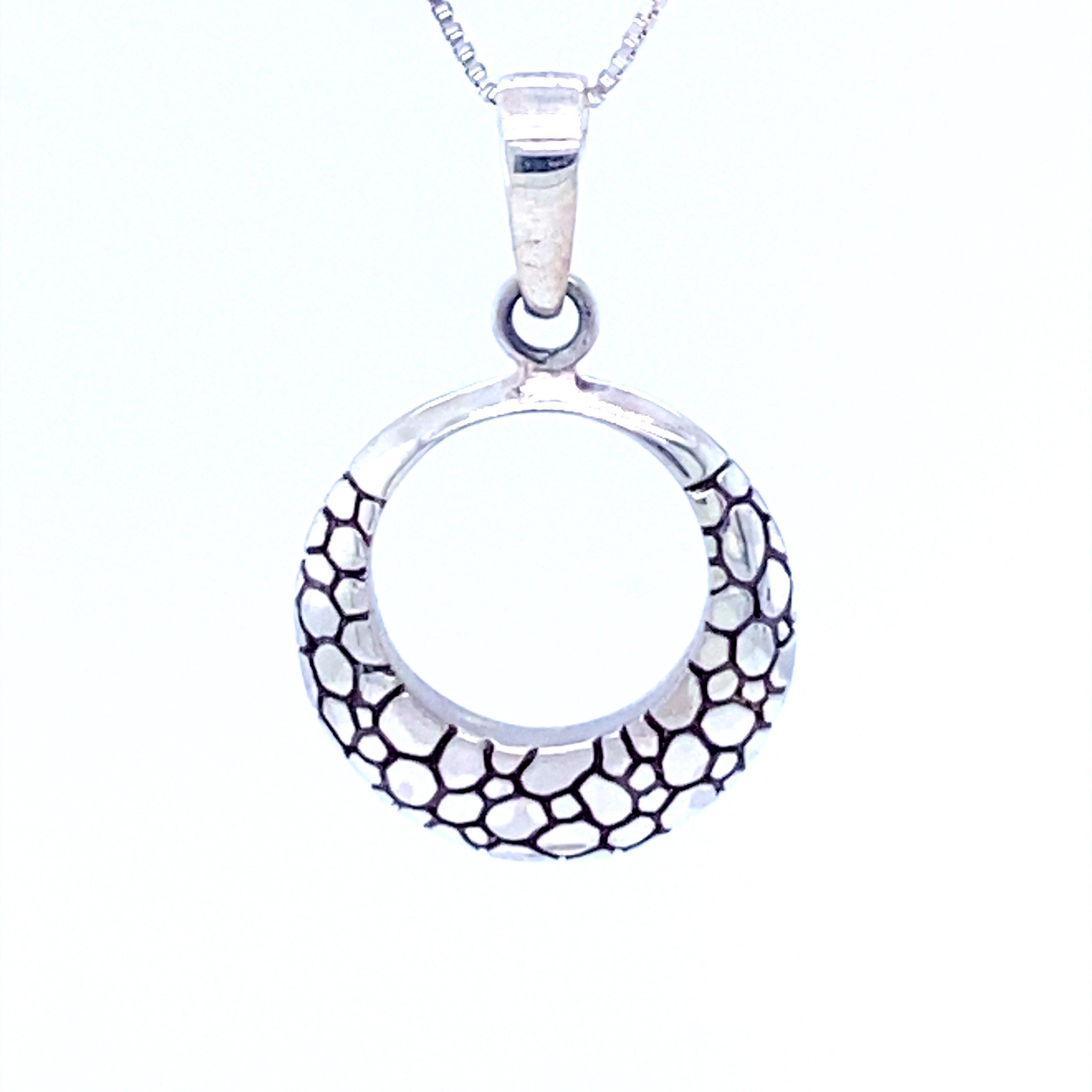 A modern take on a timeless design, this Super Silver Modern Round Cobblestone Pendant features black and white designs on a silver surface.