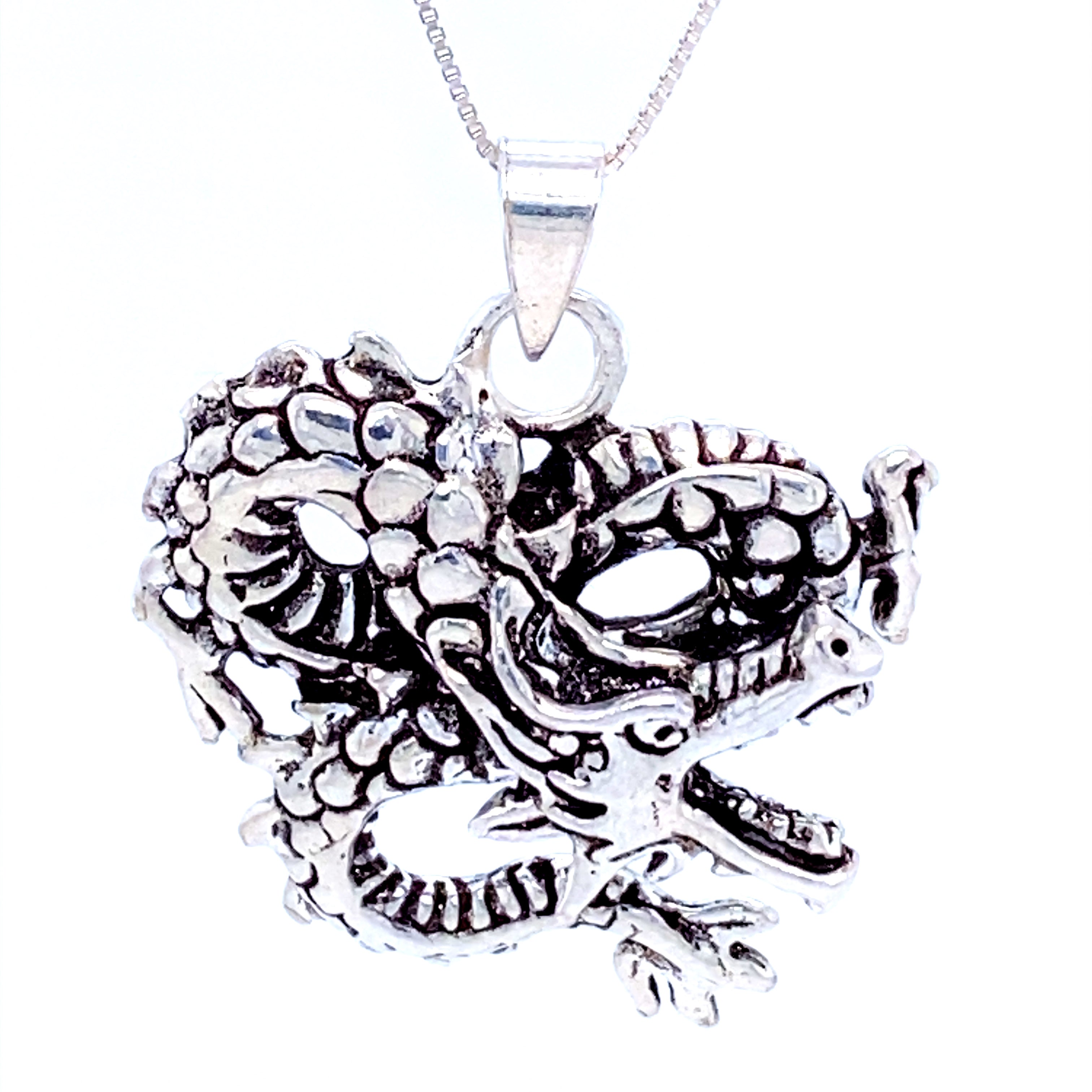 A Super Silver dragon pendant featuring fine details on a chain.