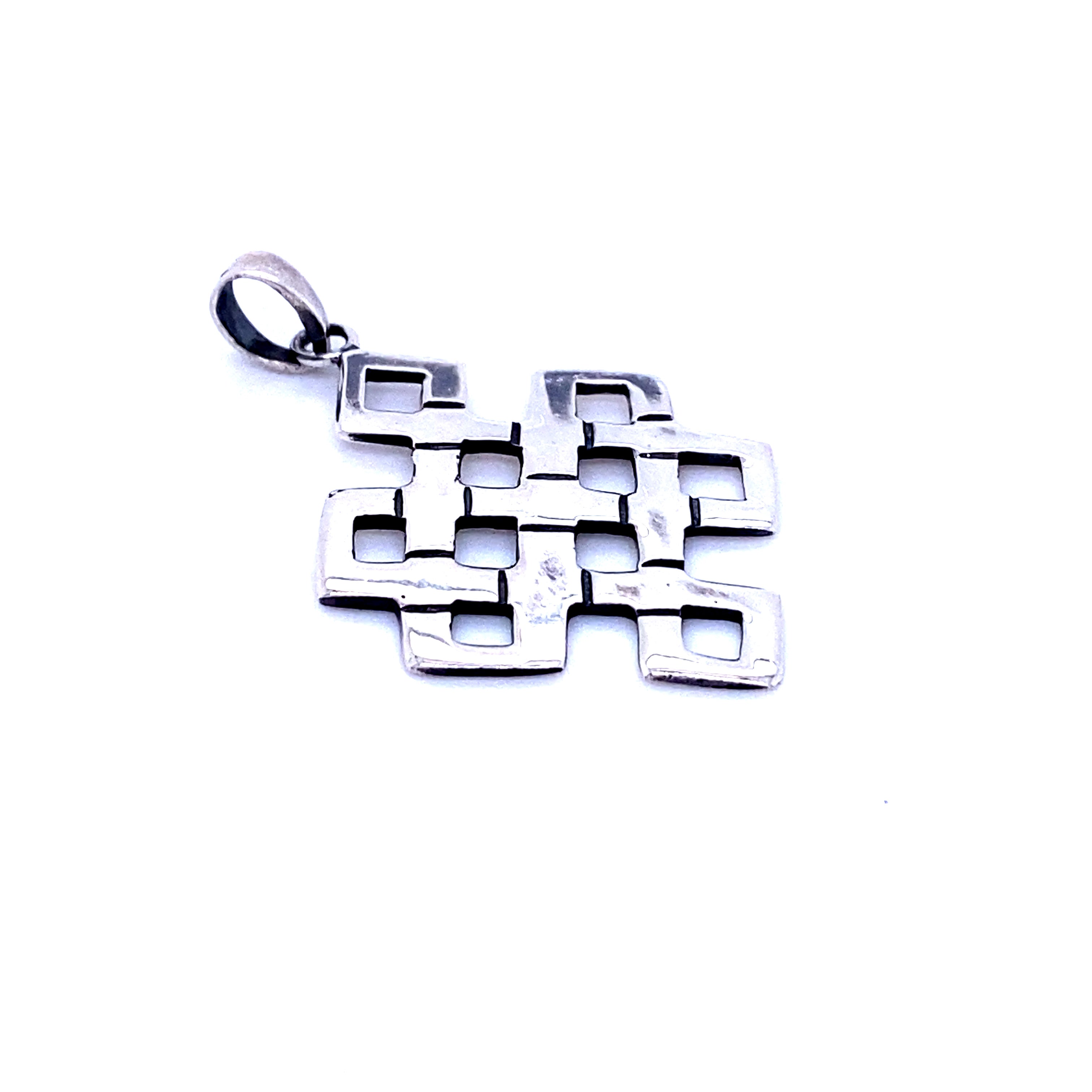The Eternal Knot Pendant is a sterling silver jewelry piece with an interlocking geometric grid and square cutouts, inspired by the eternal knot motif, shown on a white background.