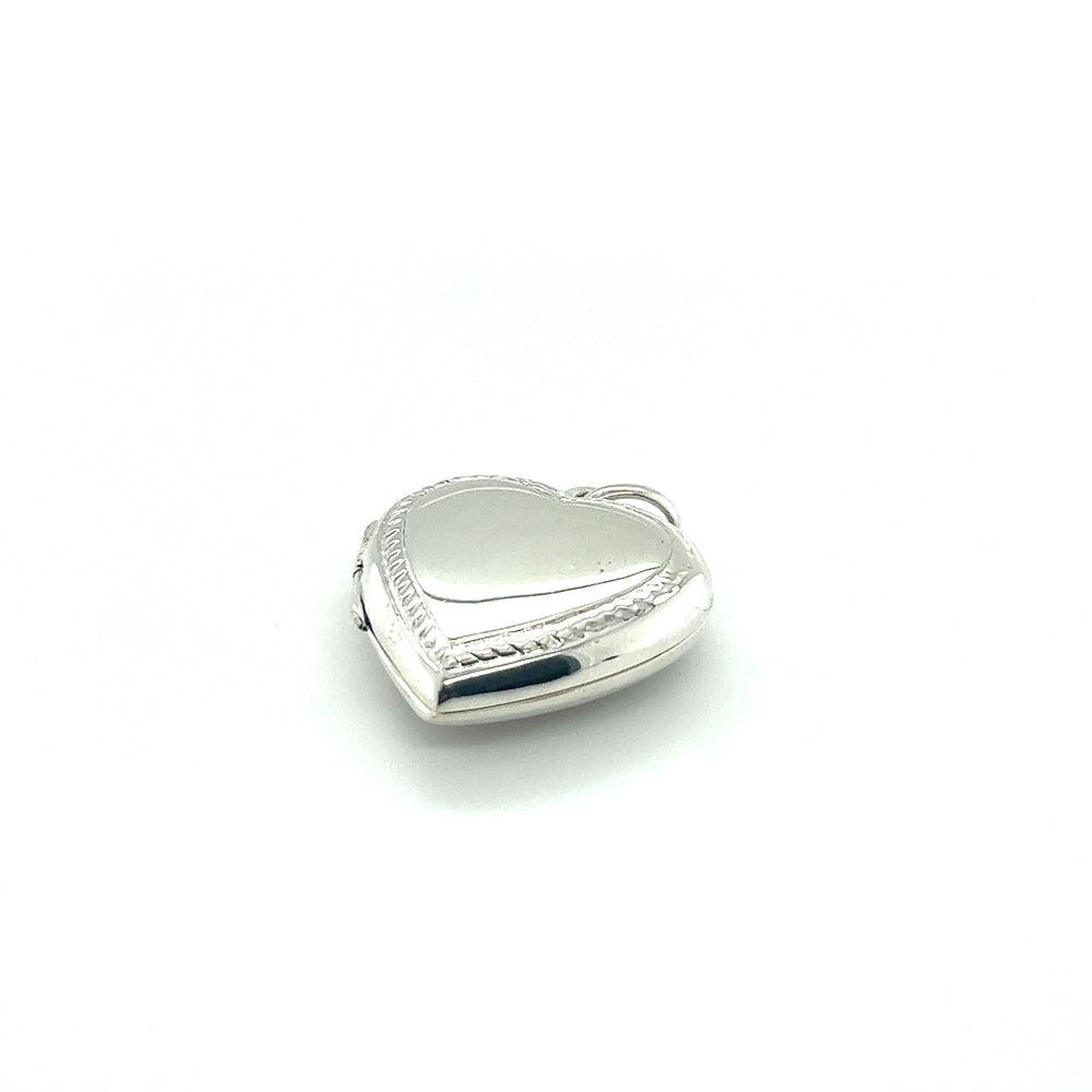 
                  
                    A Super Silver Heart Locket with Delicate Rope Border on a white background, perfect to commemorate a special memory.
                  
                