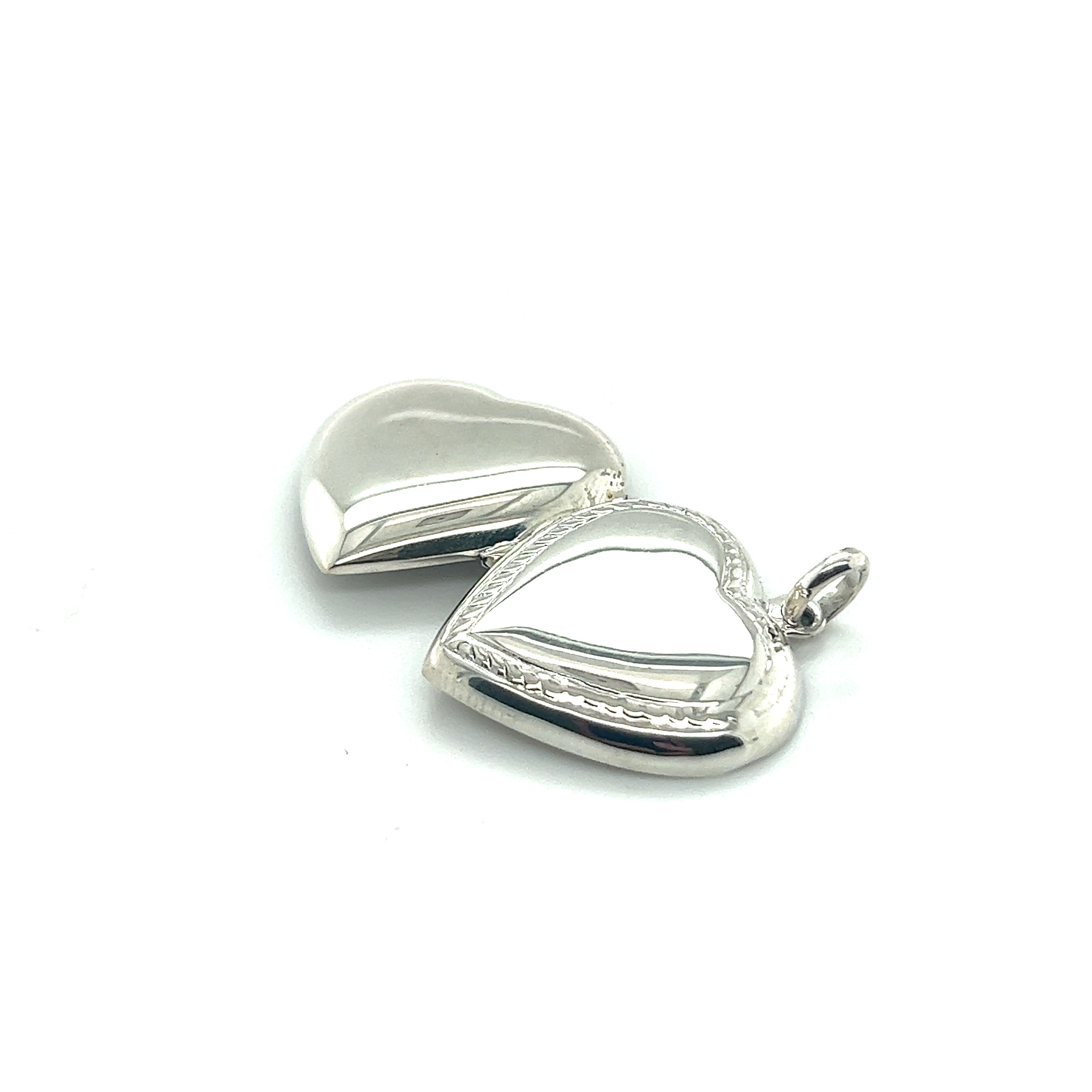 Two Super Silver Heart Lockets with Delicate Rope Border on a white background, perfect to commemorate a special someone.