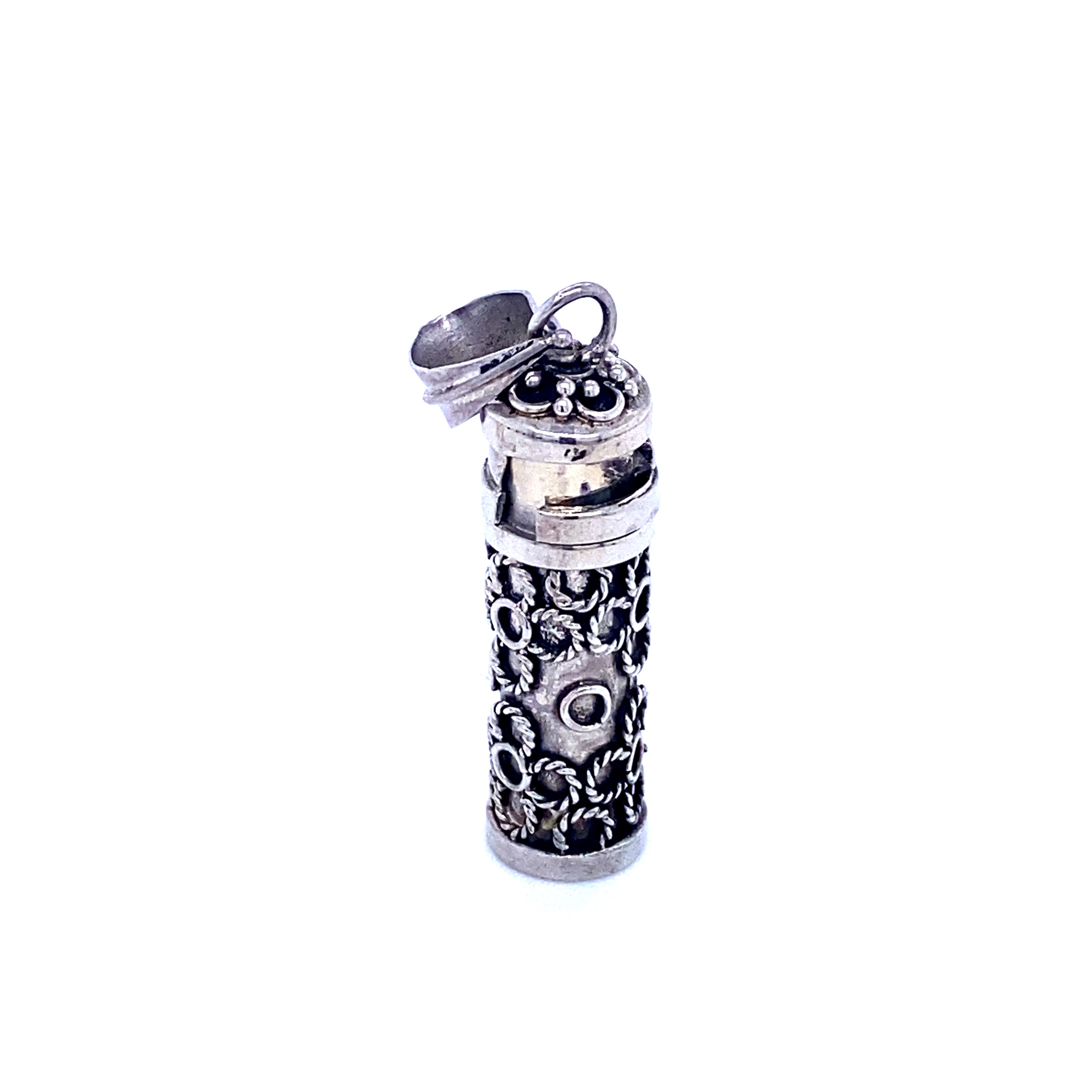 A Super Silver lighter adorned with an ornate design featuring religious scripture.