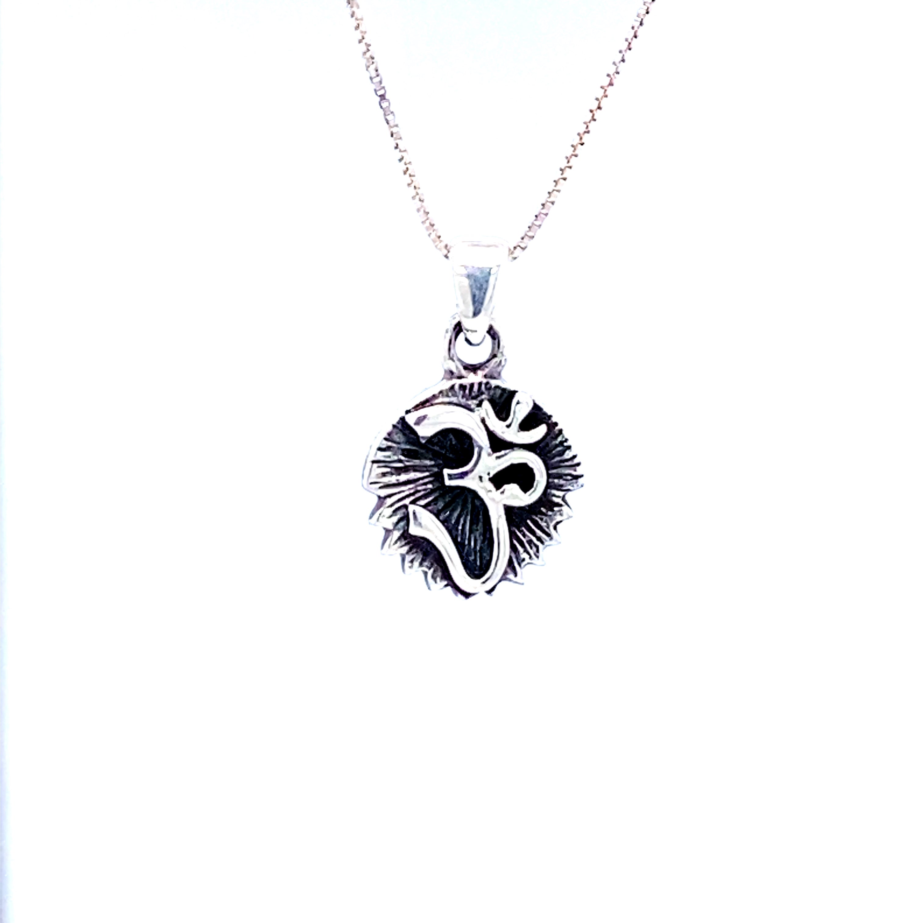 A Super Silver Om Charm with Burst Background on a white background.