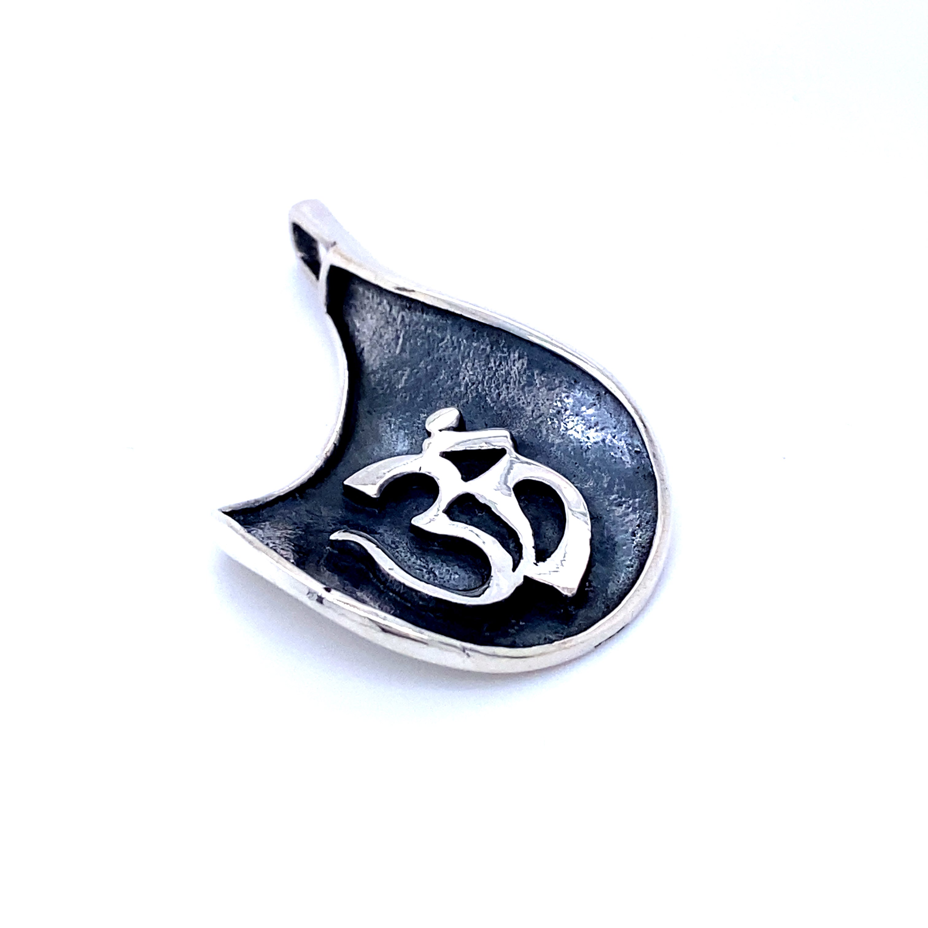 A Super Silver Om Symbol Pendant with an oxidized finish, featuring an Om symbol.