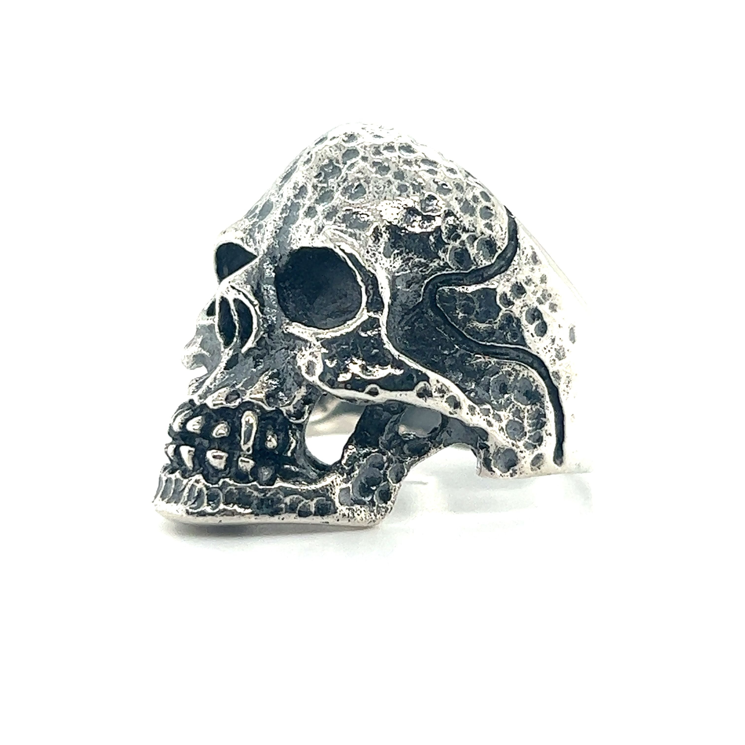 A large textured skull ring on a white background, perfect for men with a gothic style.