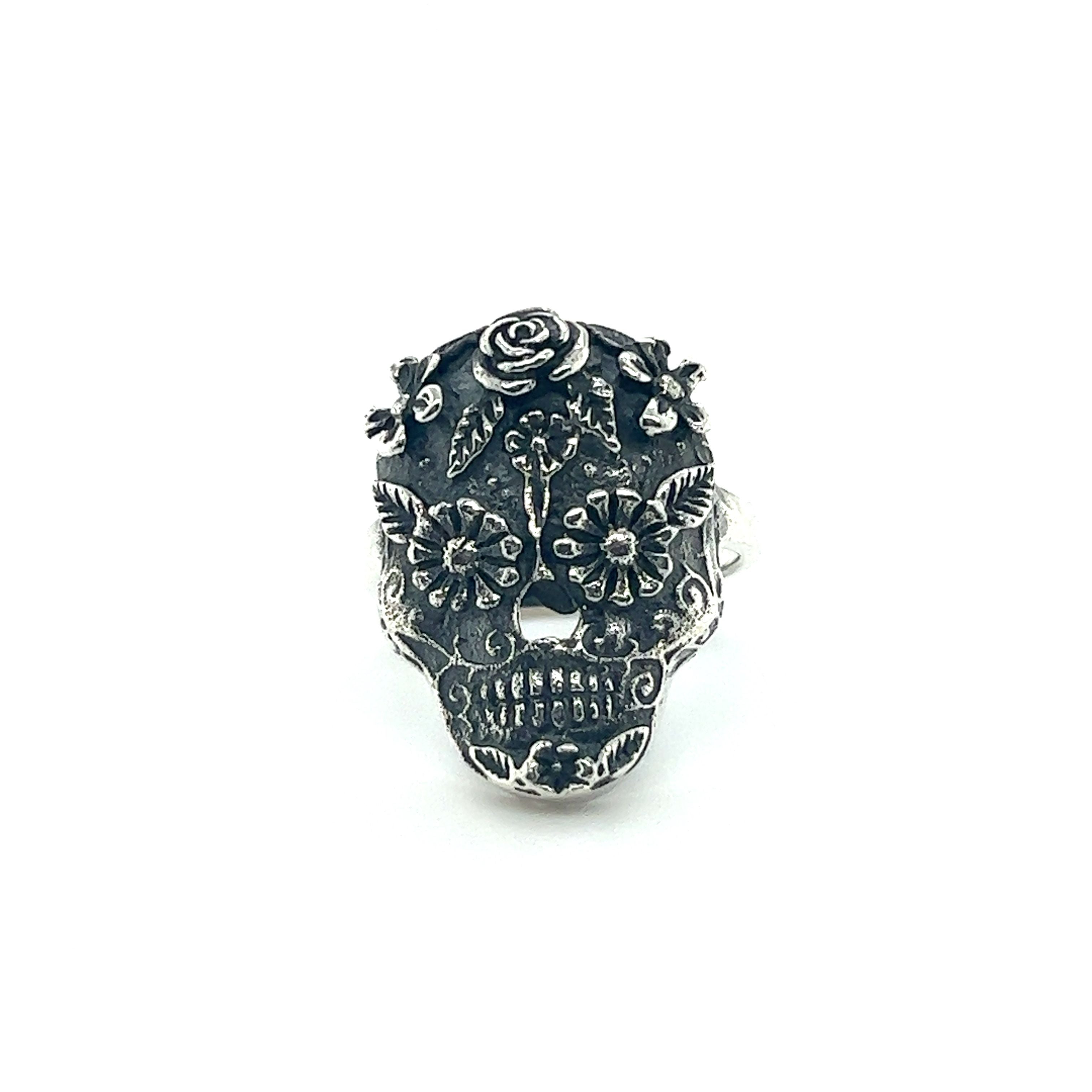 An Intricate Sugar Skull Ring on a white background, highlighting the cultural significance.
