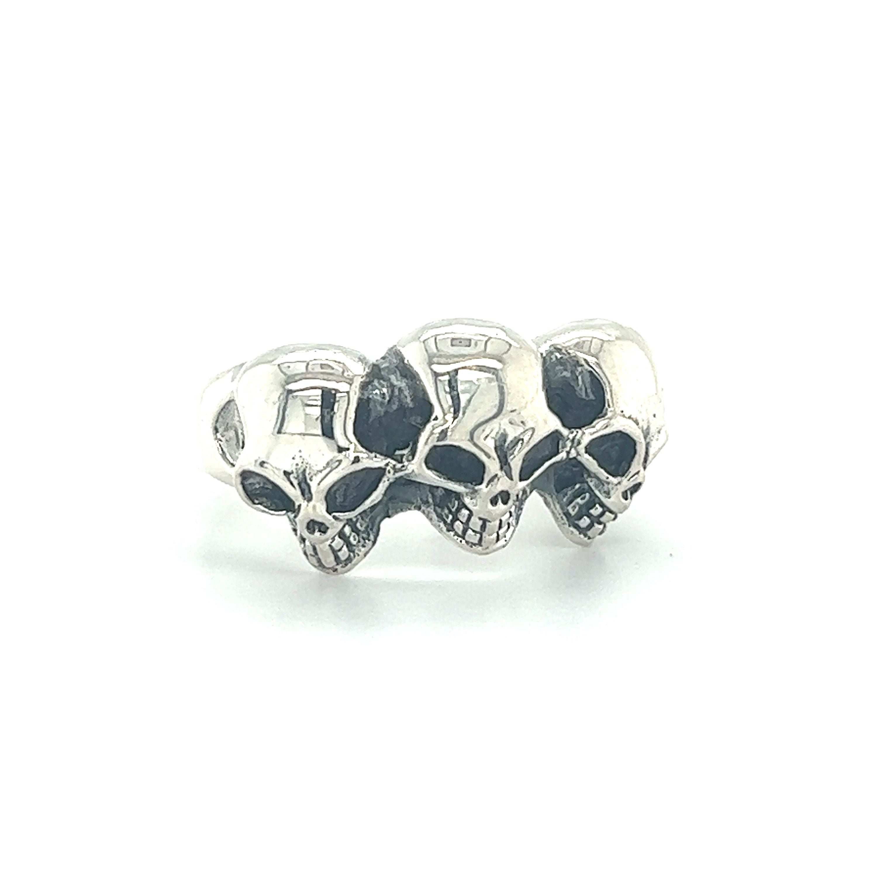 A mens silver gothic Heavy Triple Skull Ring adorned with three skulls.
