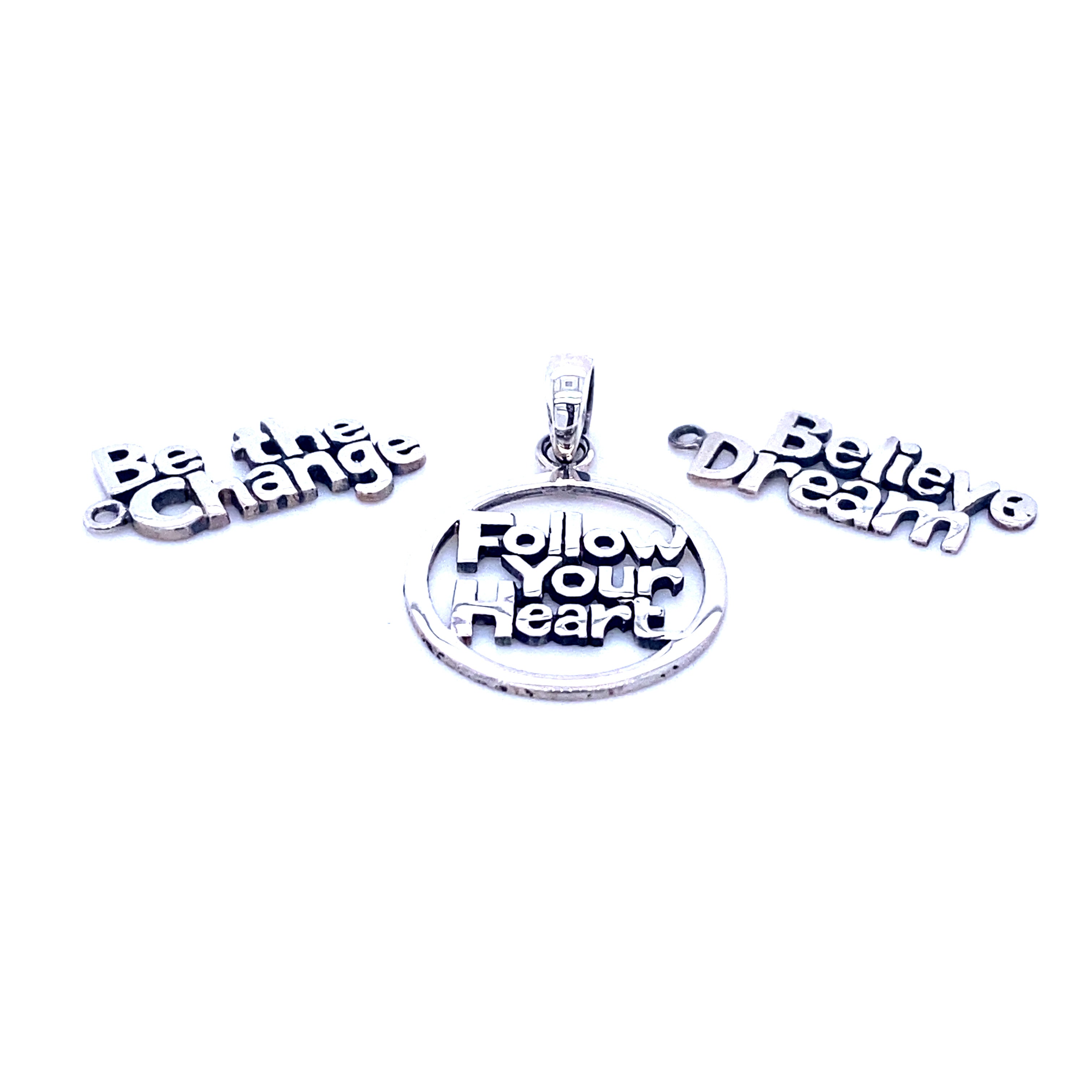 Three Super Silver Affirmation Charms with the affirmation 'follow your dream'.