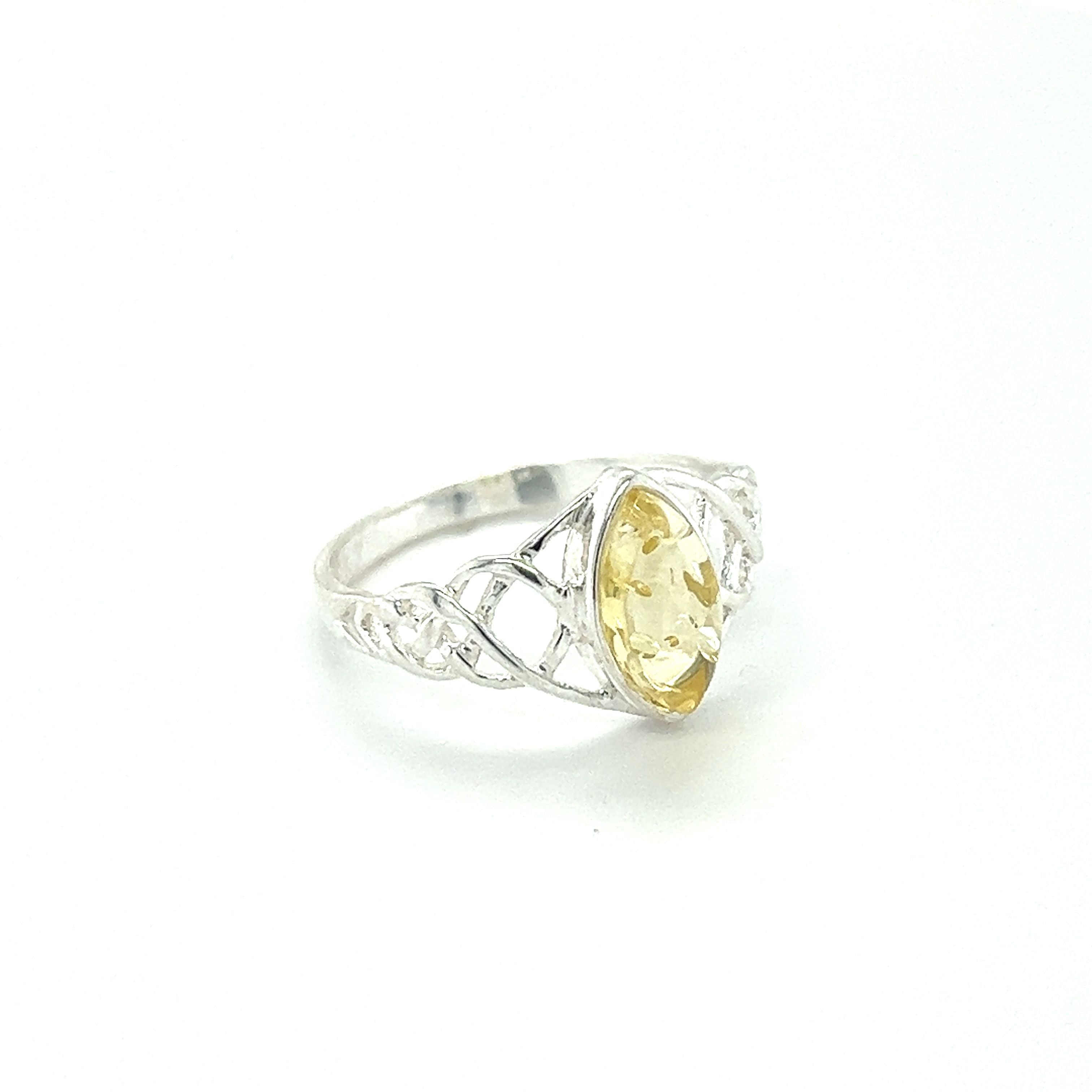 A Baltic Amber Marquise Shaped Celtic Style Ring with a glowing citrine stone and woven band from Super Silver.