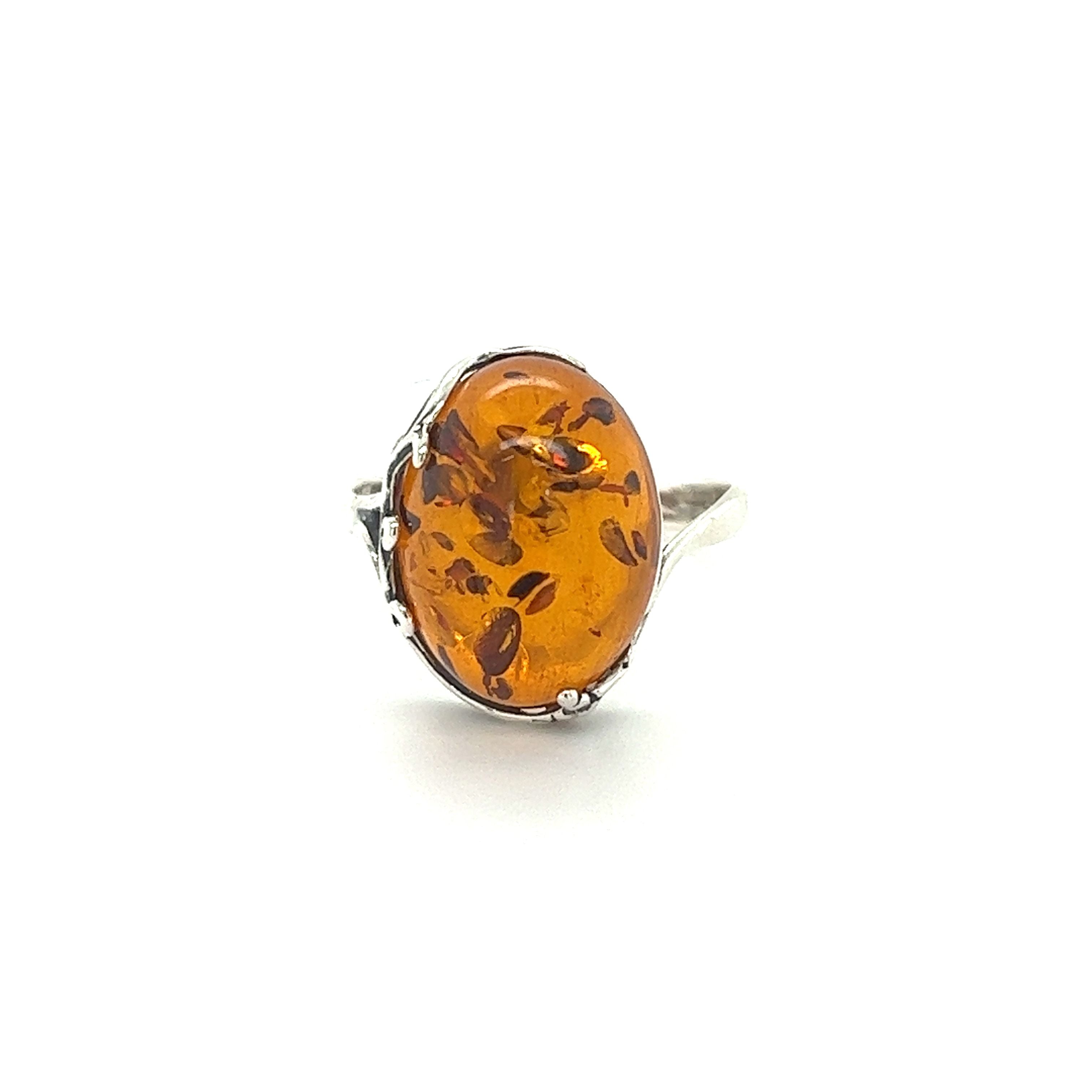 An oval Stunning Victorian Styled Amber Ring featuring a baltic stone, set against a clean white background, by Super Silver.