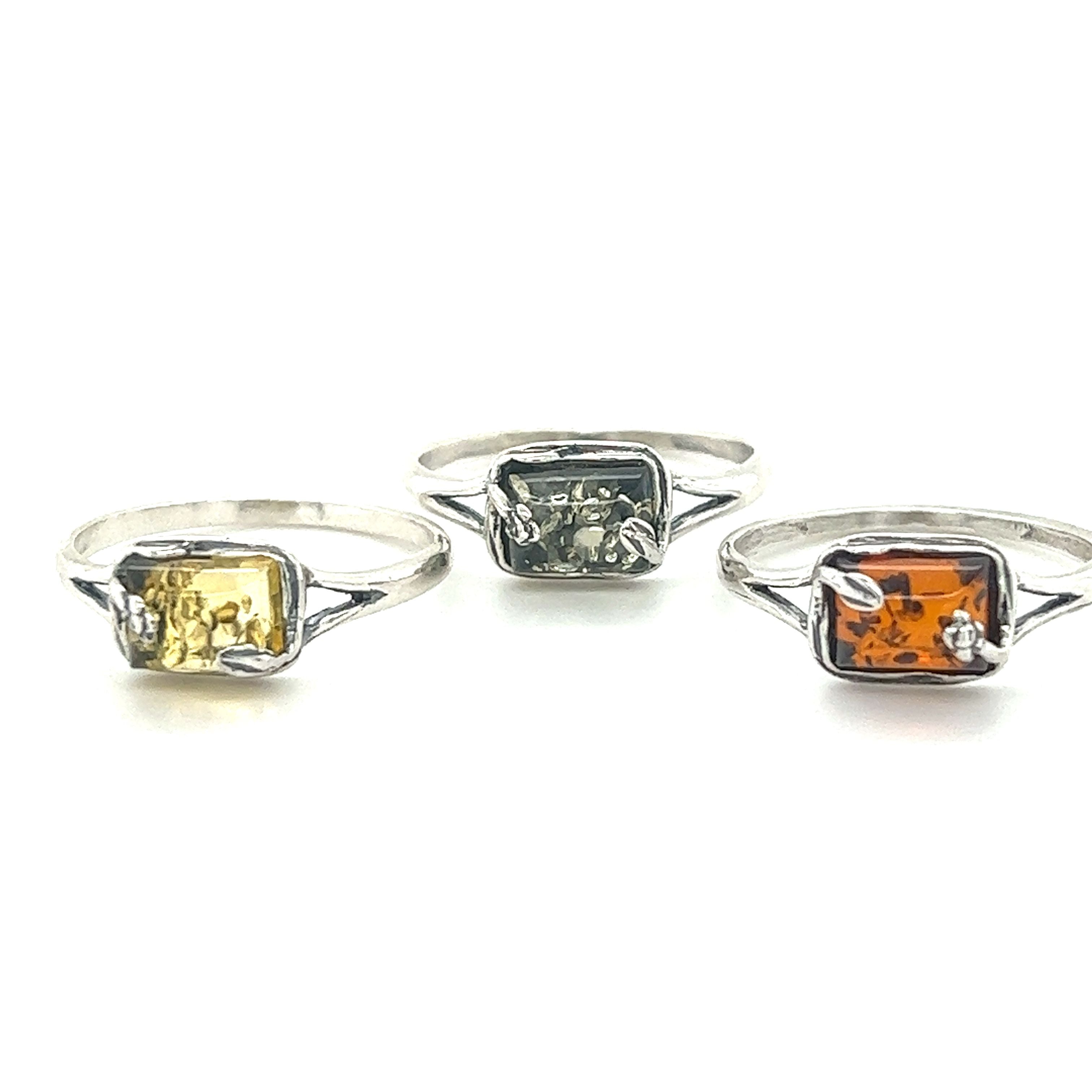 Three Rectangle Amber Rings with Baltic Amber and yellow stones, featuring a Super Silver band.