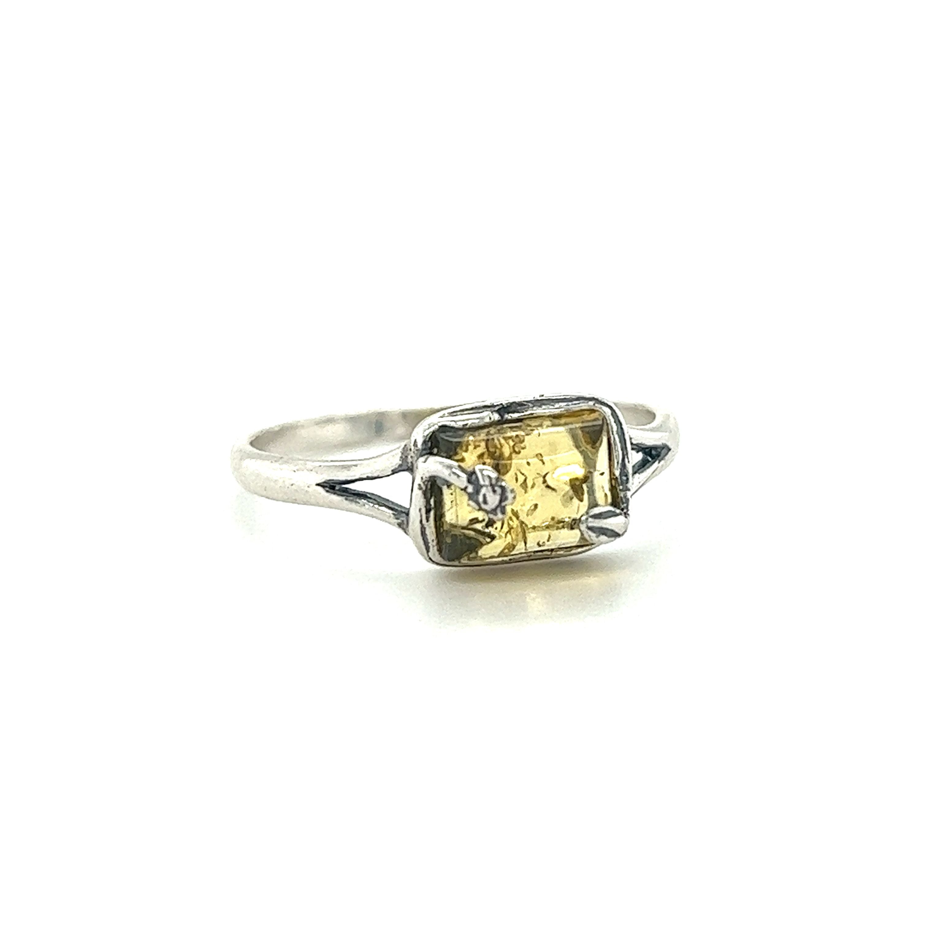 A Super Silver Rectangle Amber Ring with Nature Detailing featuring a yellow sapphire and diamonds.