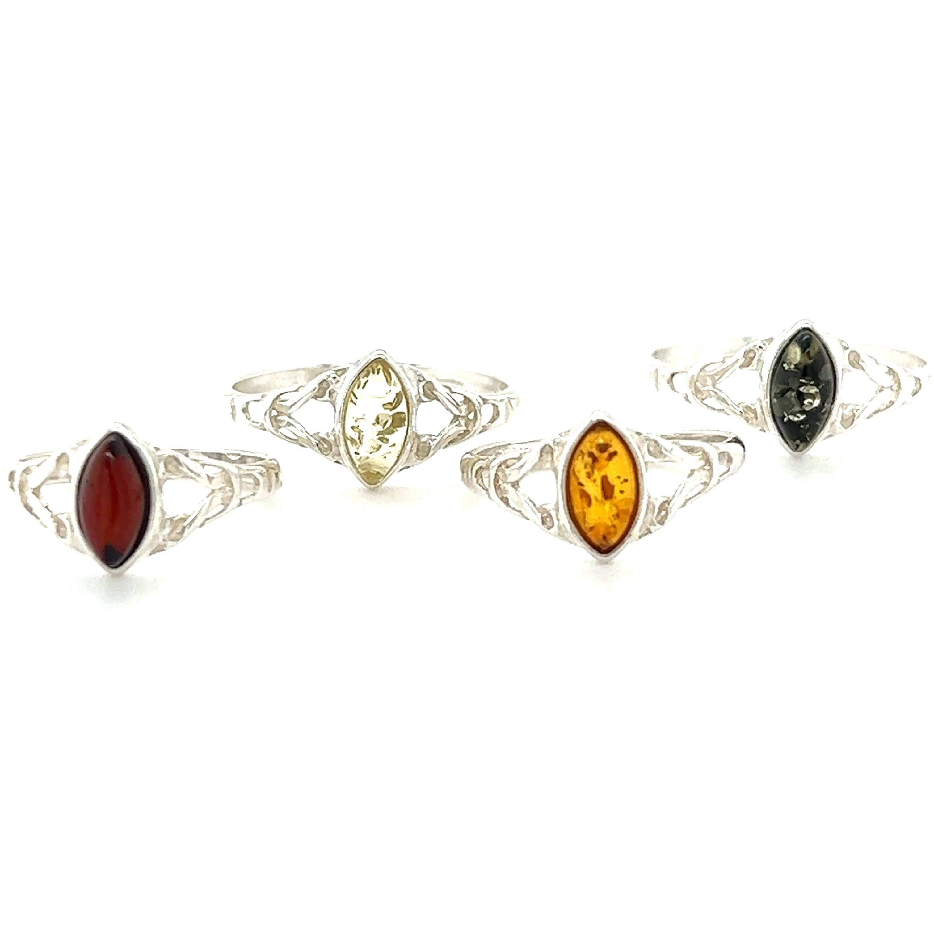 A set of Delicate Celtic Inspired Amber Rings by Super Silver with Baltic amber, amethyst, and carnelian stones. These rings not only showcase the natural beauty of these gemstones but also offer healing and spiritual growth.
