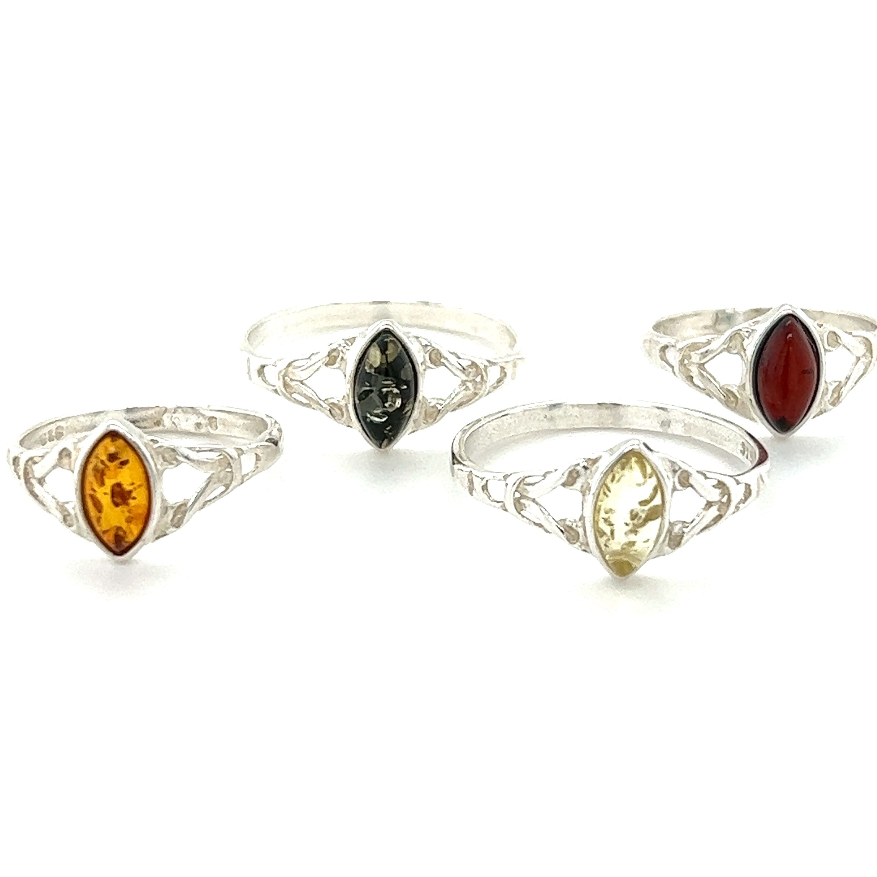 Three Delicate Celtic Inspired Amber rings crafted from .925 sterling silver. These beautiful rings feature amber and yellow stones, offering both a stylish accessory and potential healing and spiritual growth benefits. (Brand Name: Super Silver)