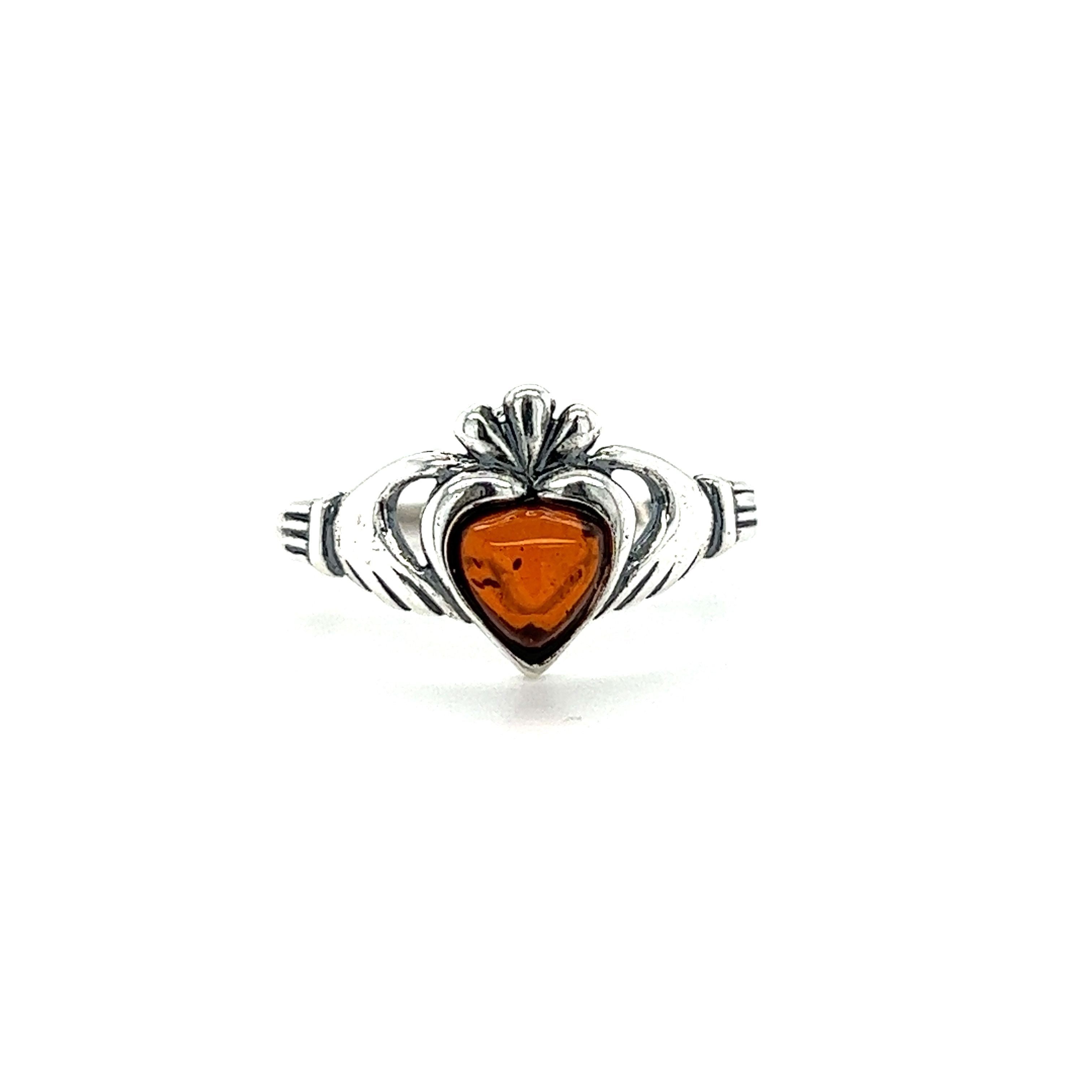 The Super Silver Claddagh Amber Heart Ring is a symbol of love and friendship, featuring a heart-shaped amber stone set in .925 sterling silver.
