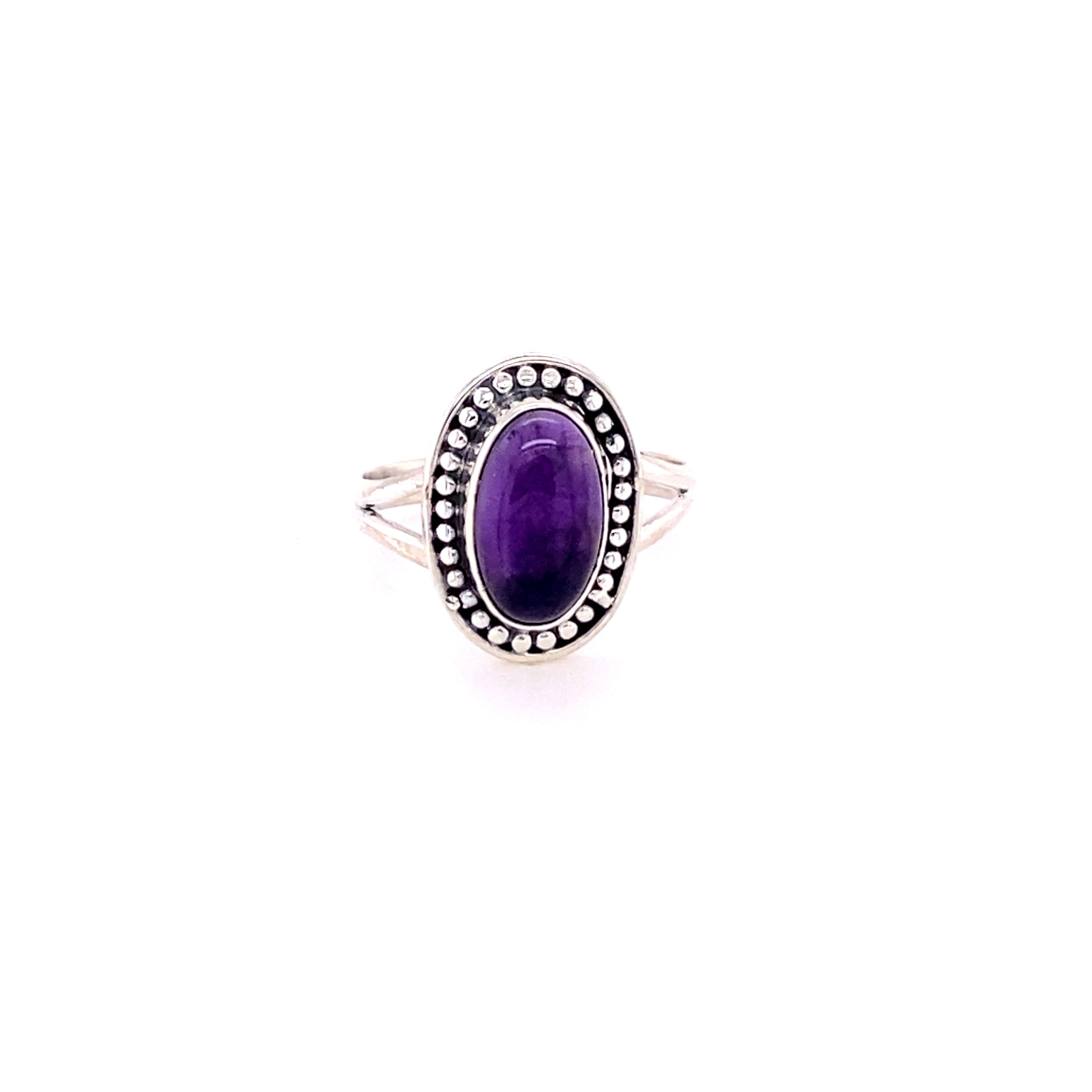 The Trendy Oval Ring, a .925 Sterling Silver creation, showcases an elegant blue stone set in a decorative bezel on a white background.