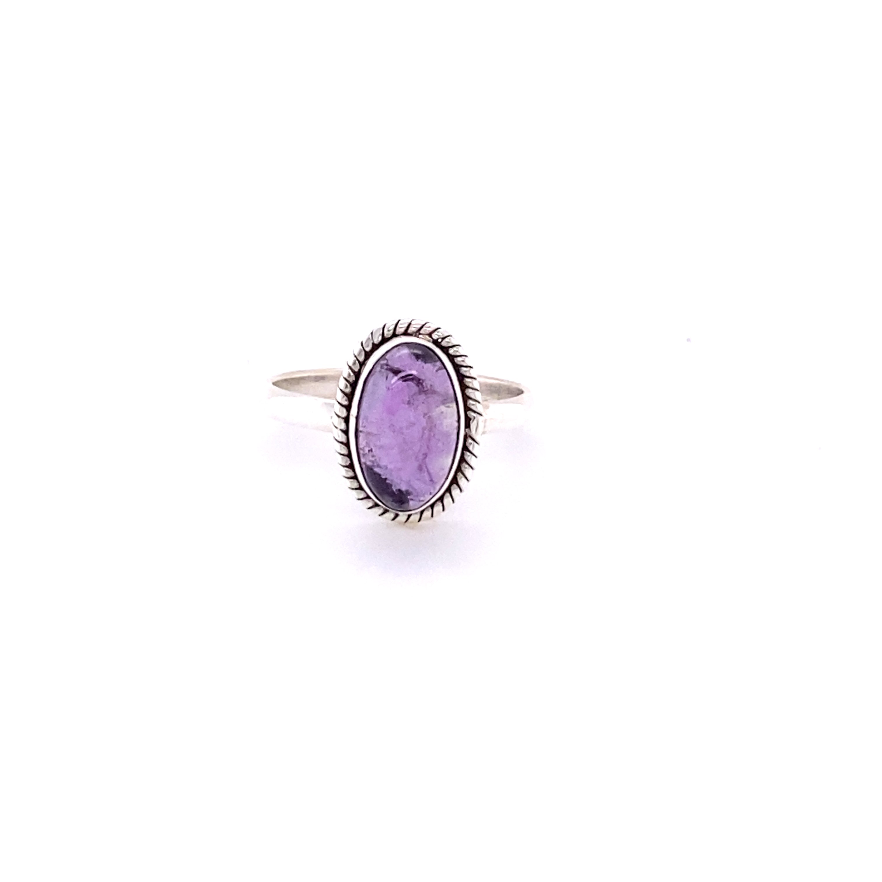 Simple Oval Gemstone Ring with Twisted Rope Border with an oval purple gemstone surrounded by a detailed, spiky bezel setting, isolated on a white background.